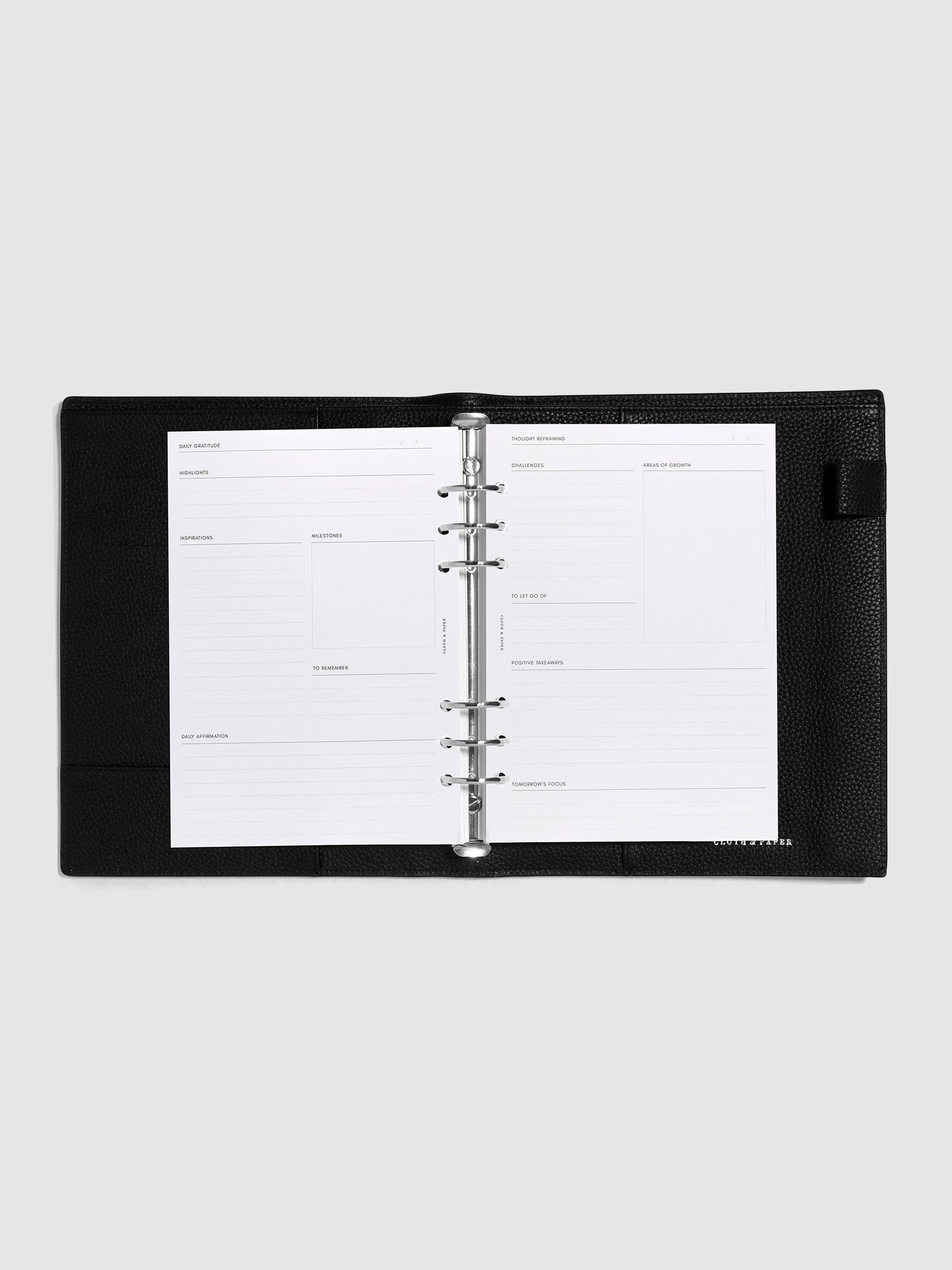 Inserts in use inside a black leather agenda.