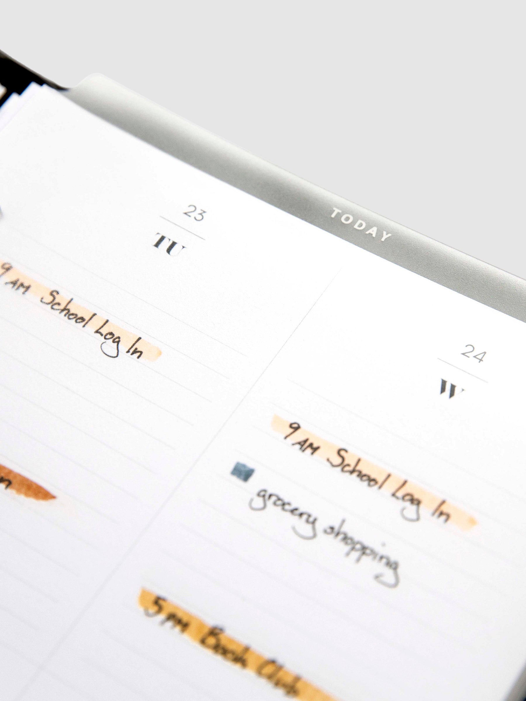 Today Dry Erase Tab Divider, White Text, Cloth and Paper. Close up on divider inside a planner against a neutral background.