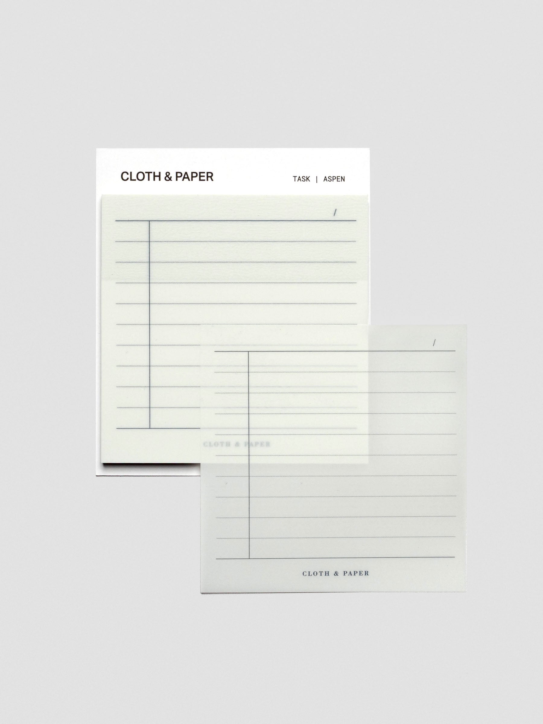 One transparent sticky note placed to the side of the pad, showing the translucent Aspen color and lined task format.