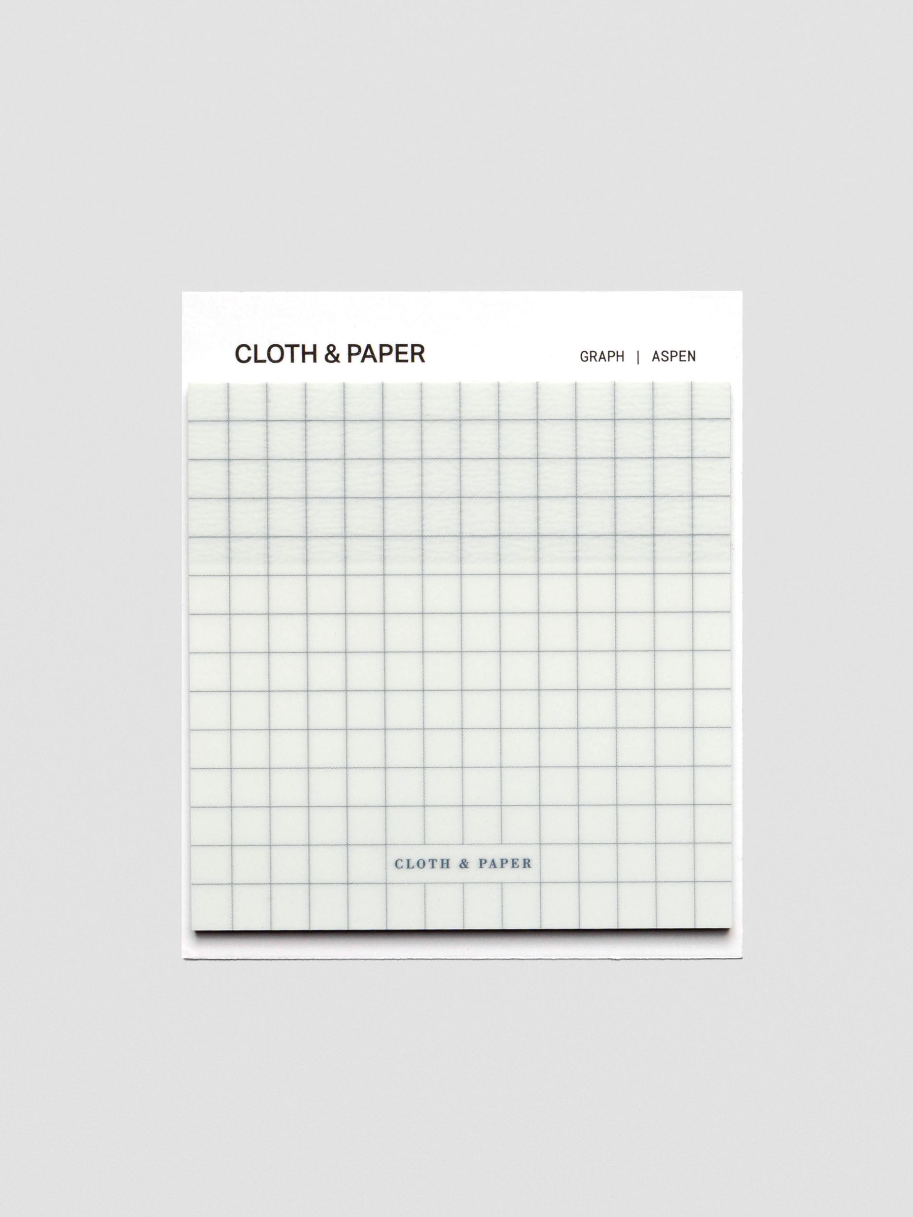 A single square transparent sticky note pad with an all-over graphite grid design, packaged with Cloth & Paper branding at the top.