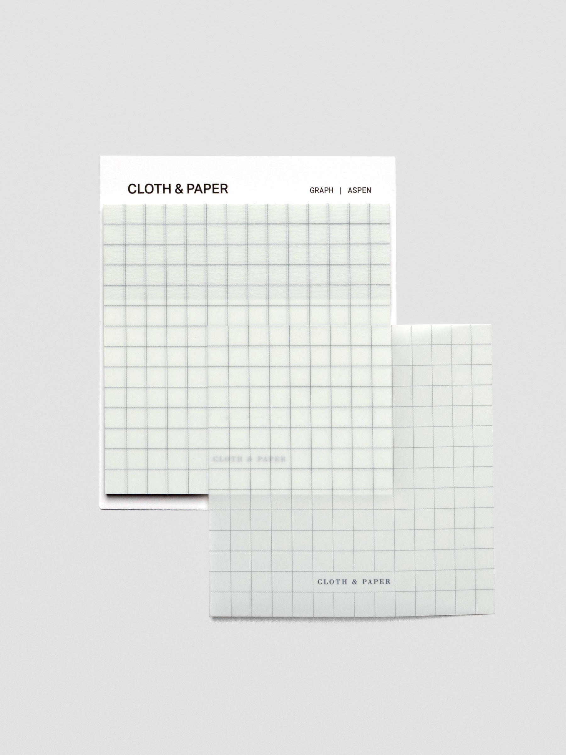 One transparent graph sticky note, placed on the side of the pad, stacked slightly off-center to display the transparent design.
