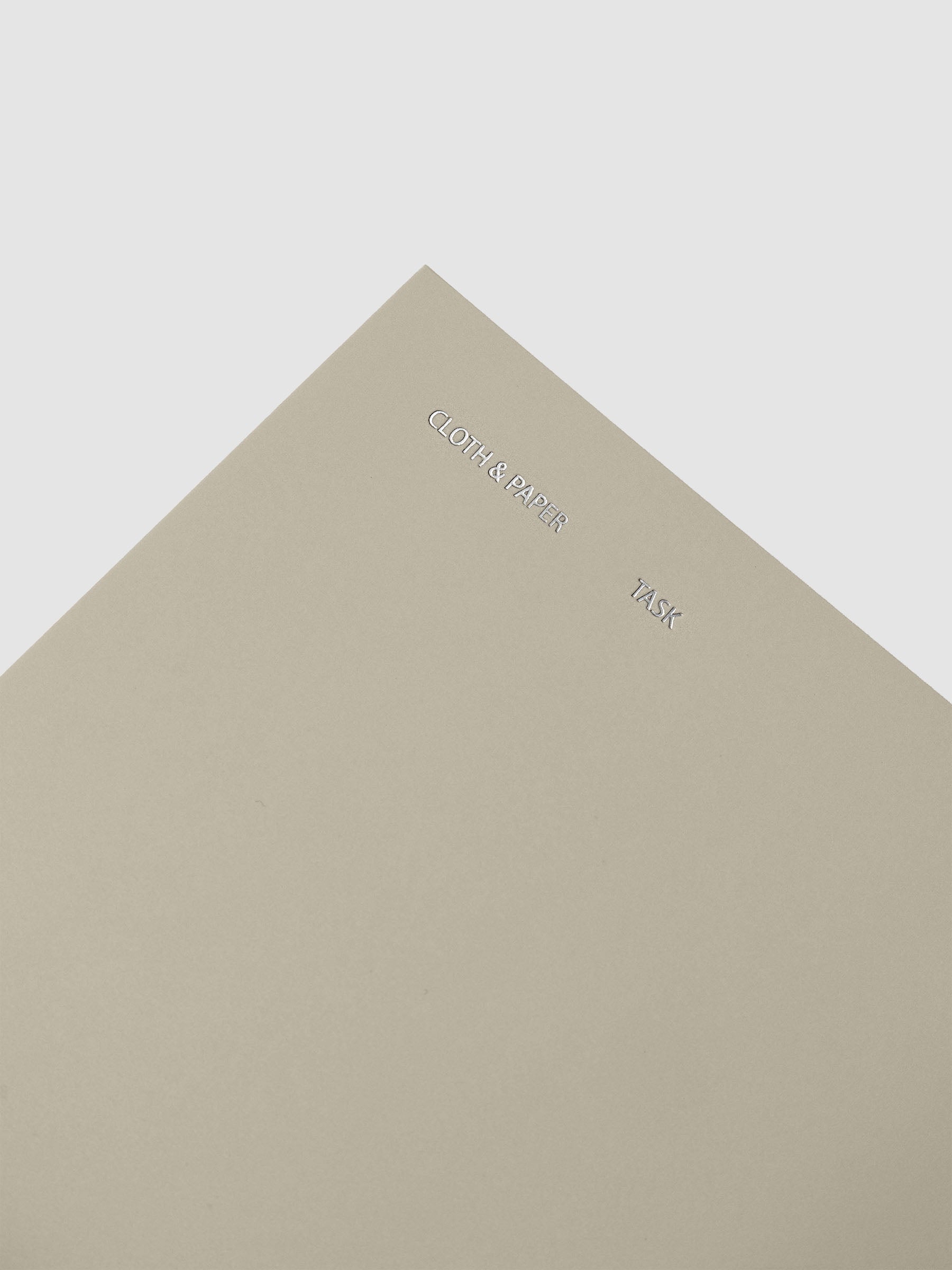 Travel Notebook in size A5 Slim in the color Ristretto with Task layout shown close up on the cover for foil details.