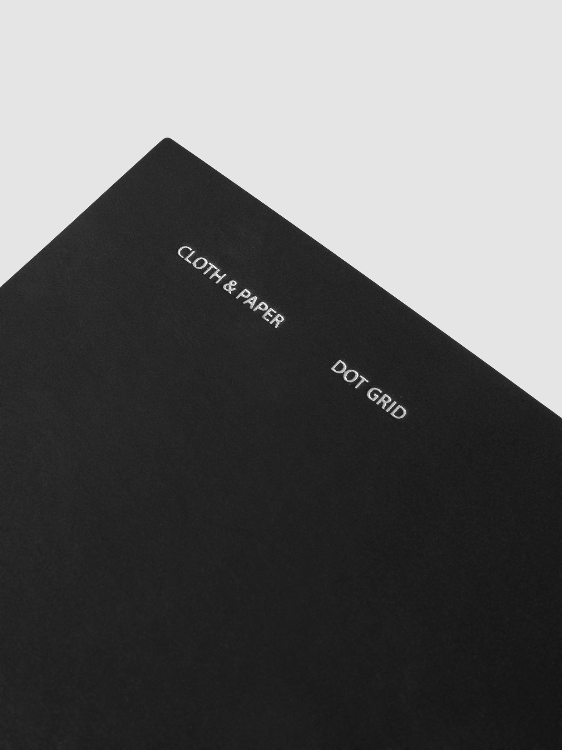 Close up of foil details on cover for Travel Notebook | Pocket Plus | Avant Garde | Dot Grid shown against a neutral background.