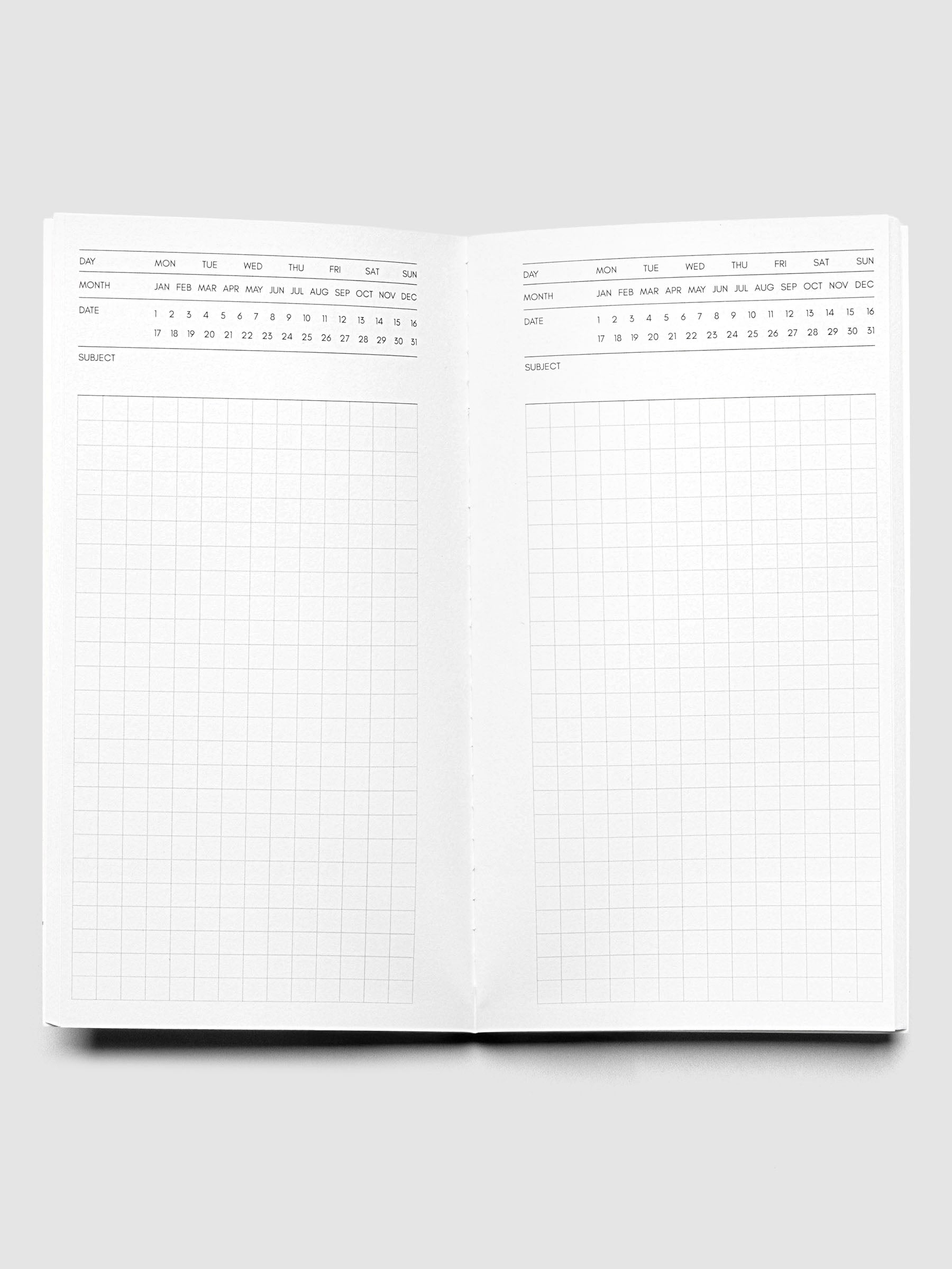 Travel Notebook | Pocket Plus | Cafe Noir | Executive shown open displaying Executive Notes style inserts with graph note space and headers for the day, month, date, and subject.
