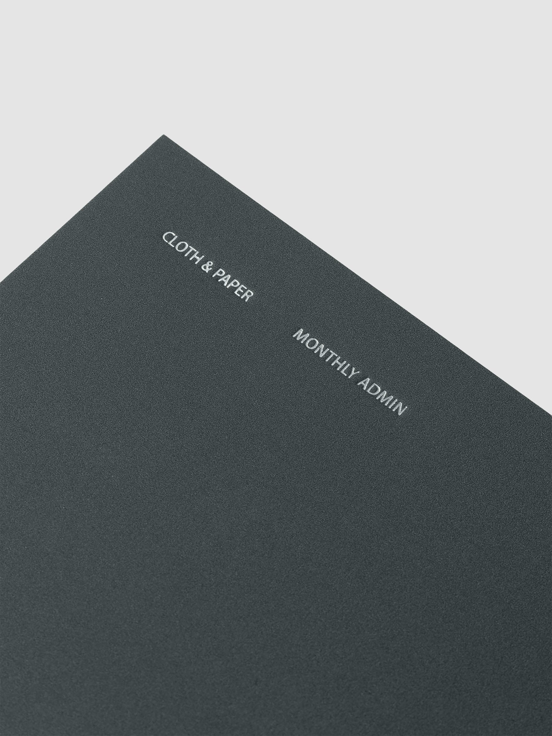 Close up of cover foil details on the Travel Notebook | Pocket Plus | Lagoon | Monthly Admin shown against a neutral background.