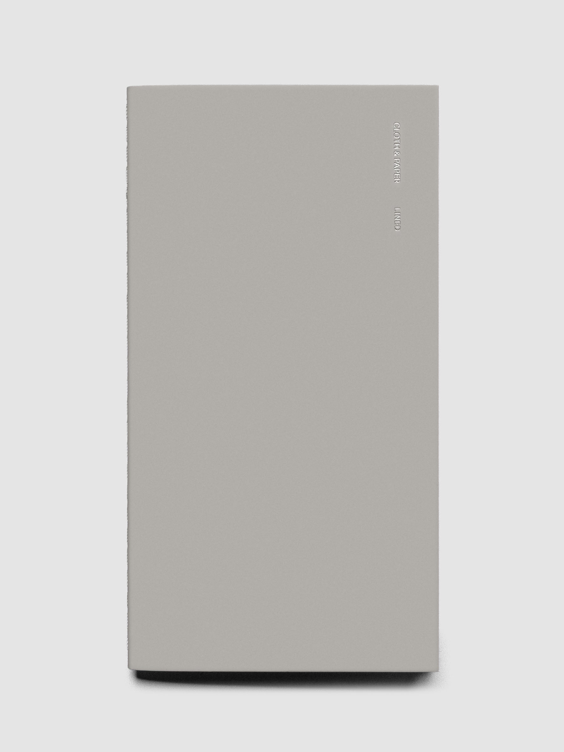 Travel Notebook in size Pocket Plus in the color Ash (grey) containing lined notes layouts shown closed from the front.