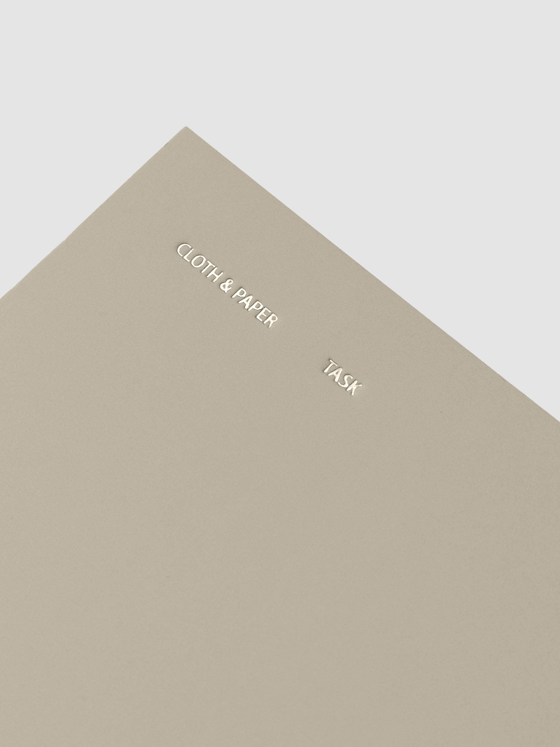 Travel Notebook | Pocket Plus | Ristretto | Task shown closed, close up, displaying foil details on cover.