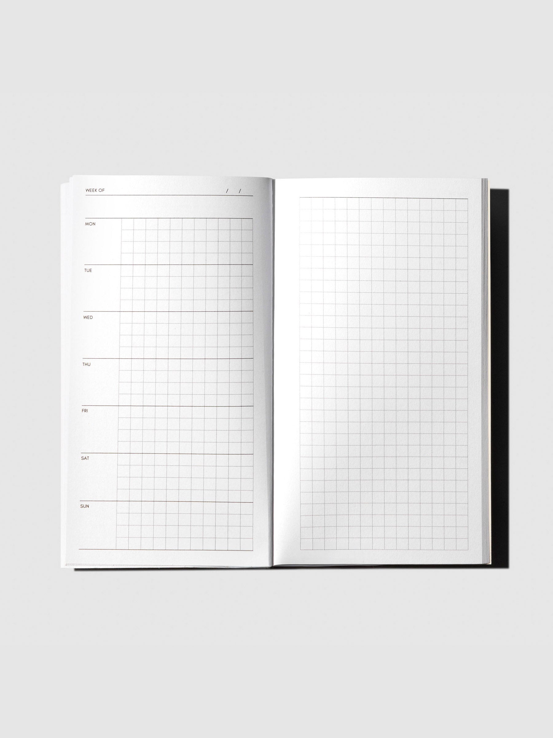 Inside spread of the Travel Notebook | Pocket Plus | Weekly Hobonichi Style, featuring a weekly grid layout on the left page and a full grid notes page on the right.