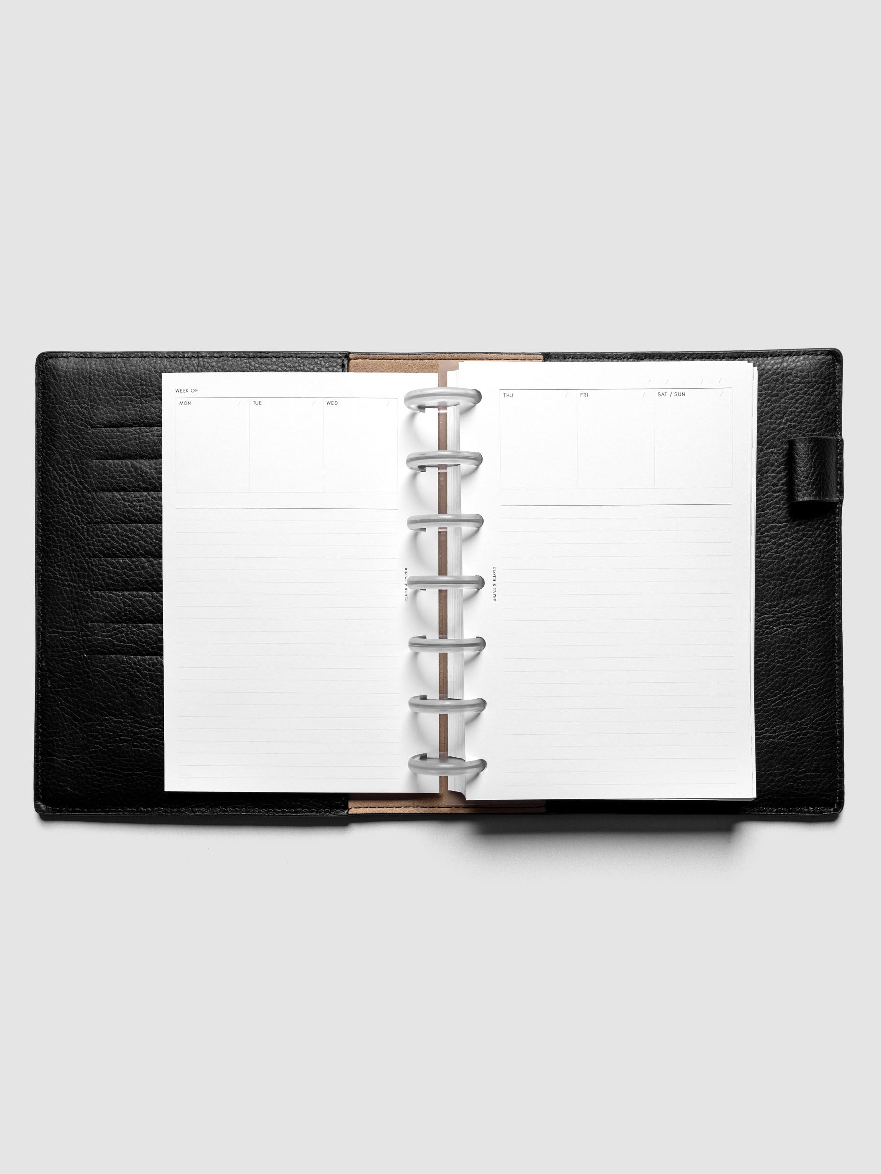 HP Mini Undated Weekly Notes Planner Inserts discbound in a black leather folio.