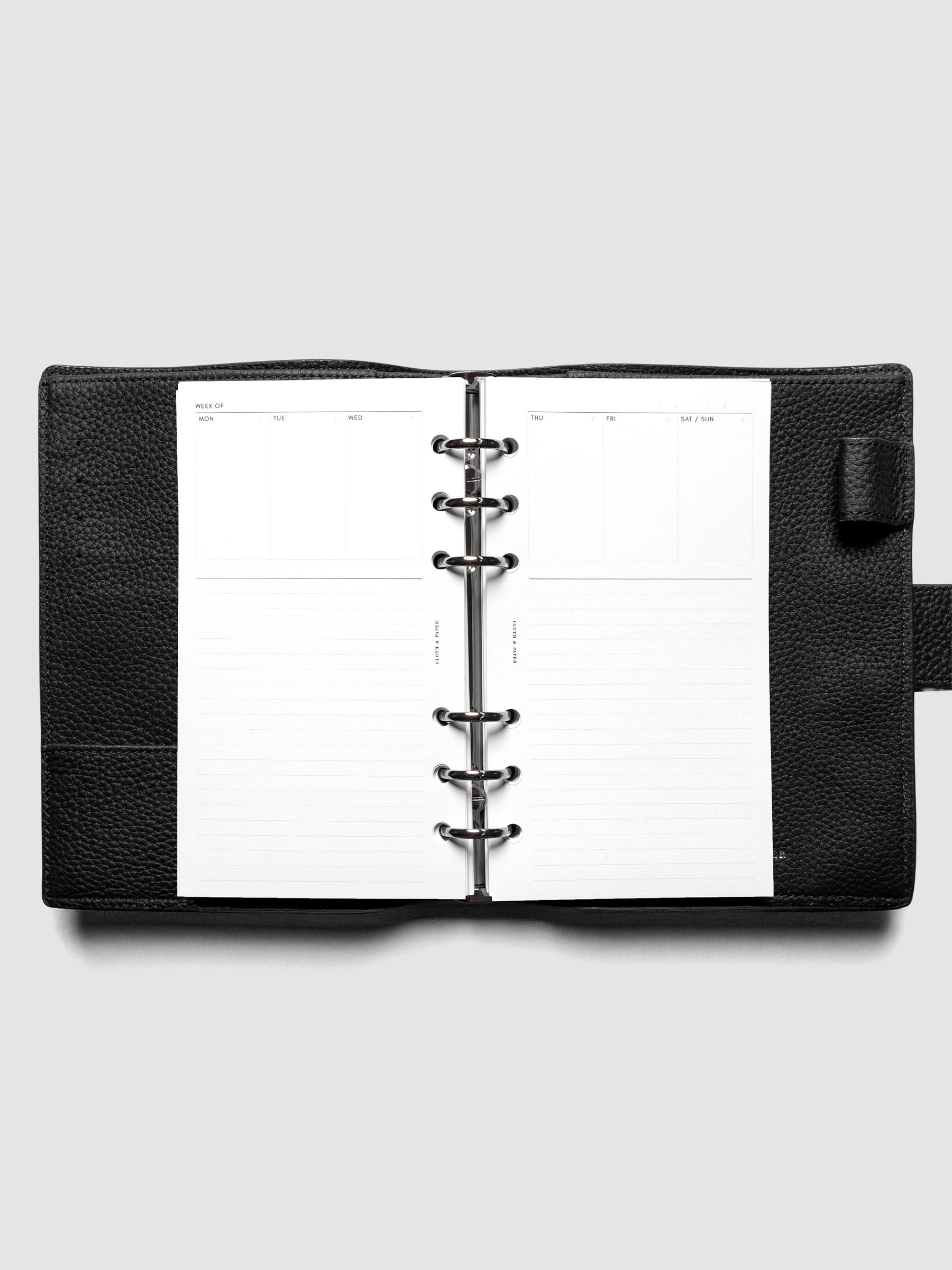 Personal Undated Weekly Notes Planner Inserts ringbound in a black leather agenda.