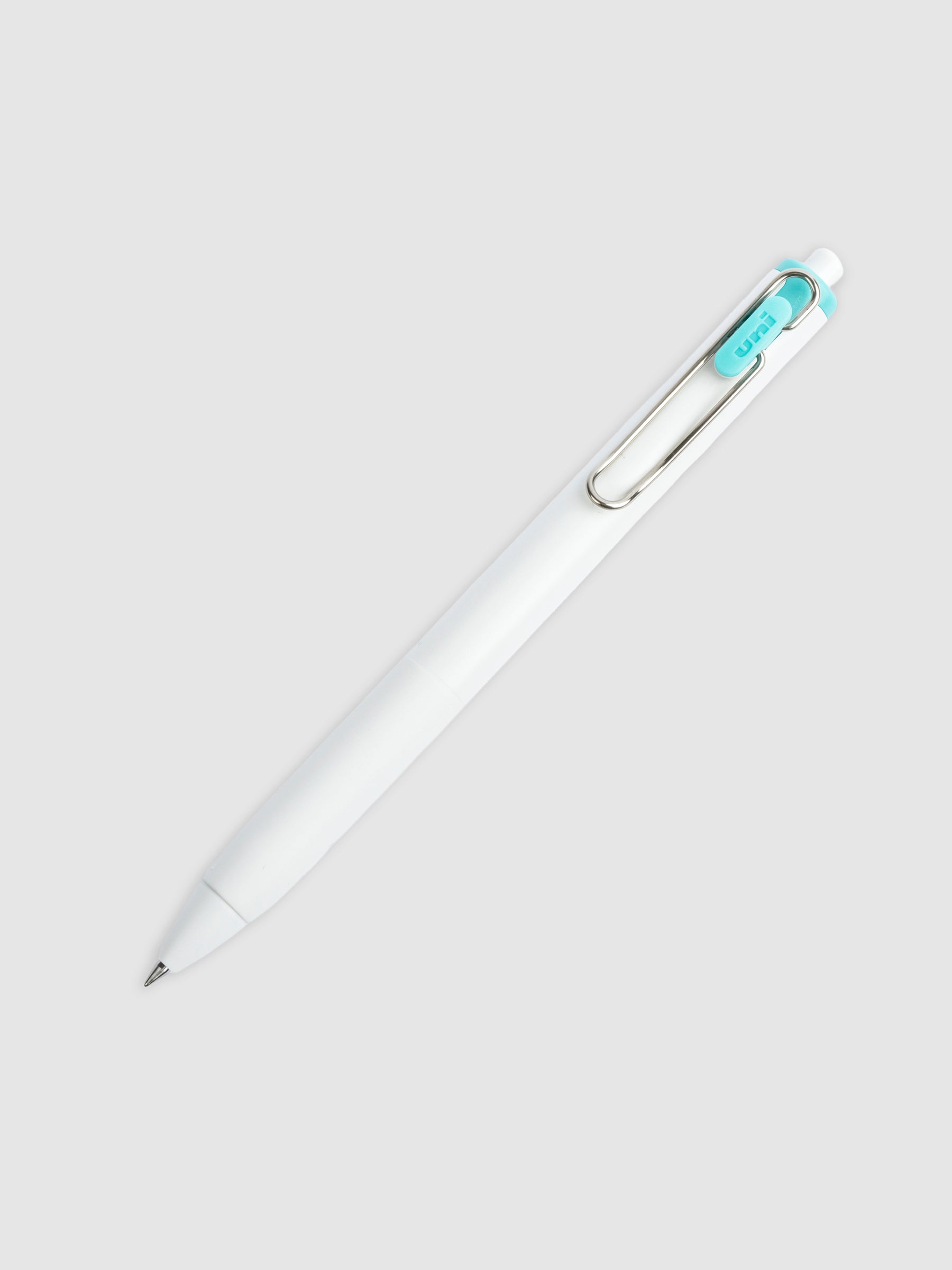 Uni-ball One Gel Pen, Neon Green, Cloth and Paper. Pen tilted slightly to the right on a neutral background.