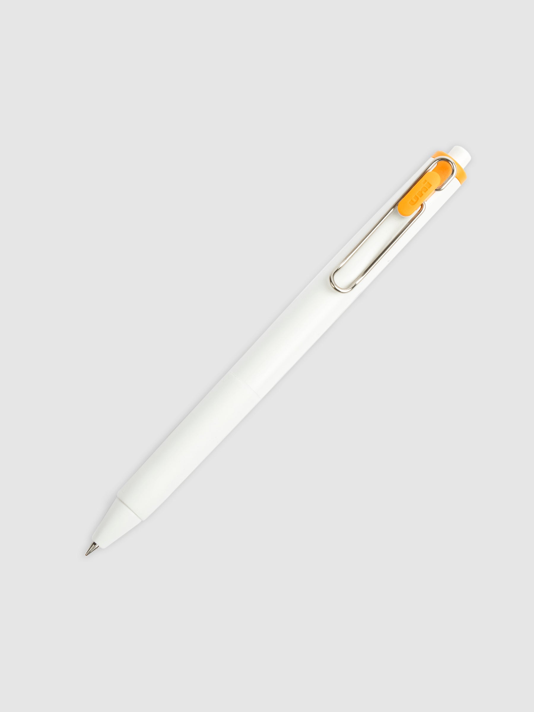 Uni-ball One Gel Pen, Orange Cocktail, Cloth and Paper. Pen tilted slightly to the right on a neutral background.