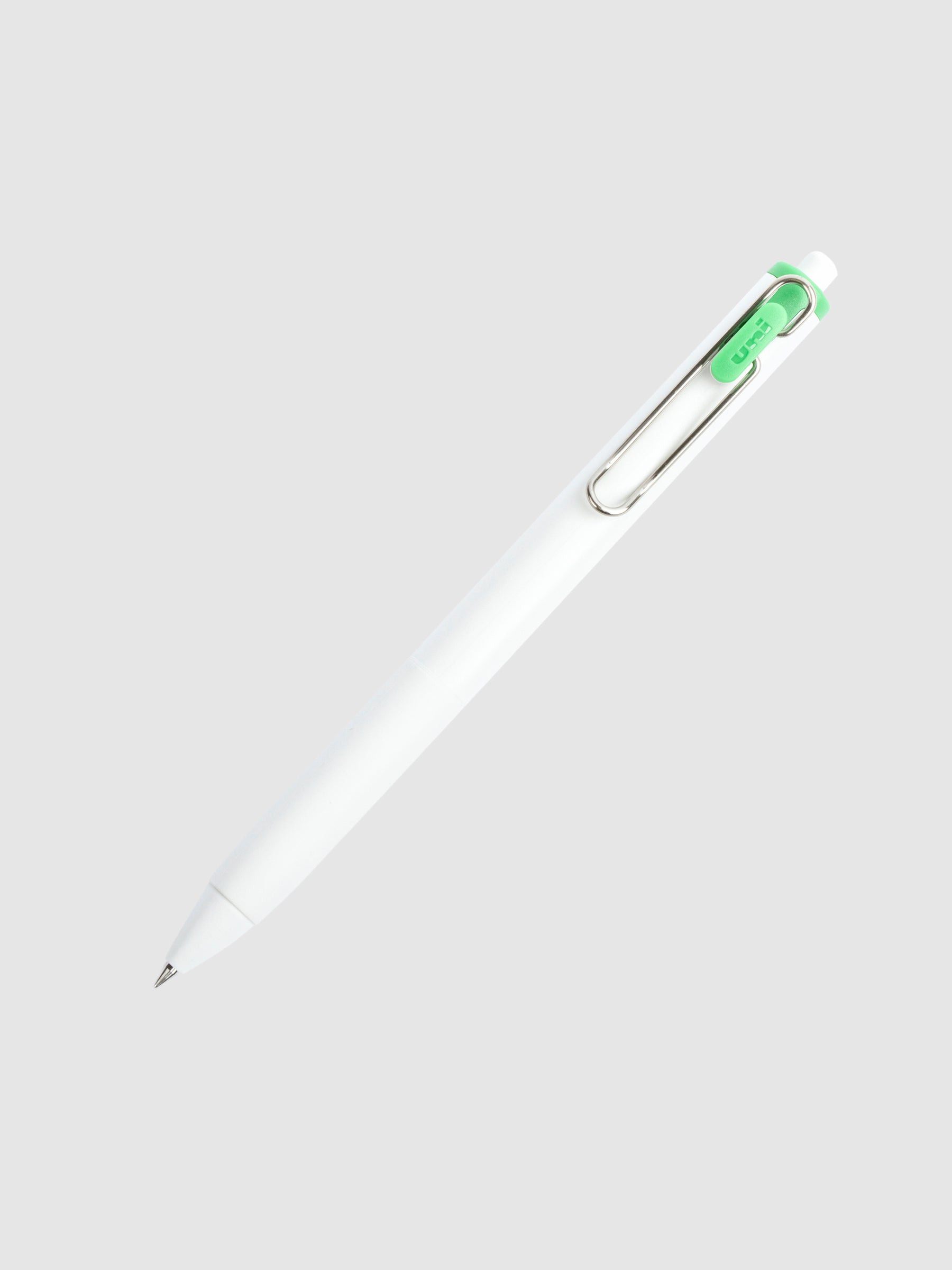 Uni-ball One Gel Pen, Palm Green, Cloth and Paper. Pen tilted slightly to the right on a neutral background.