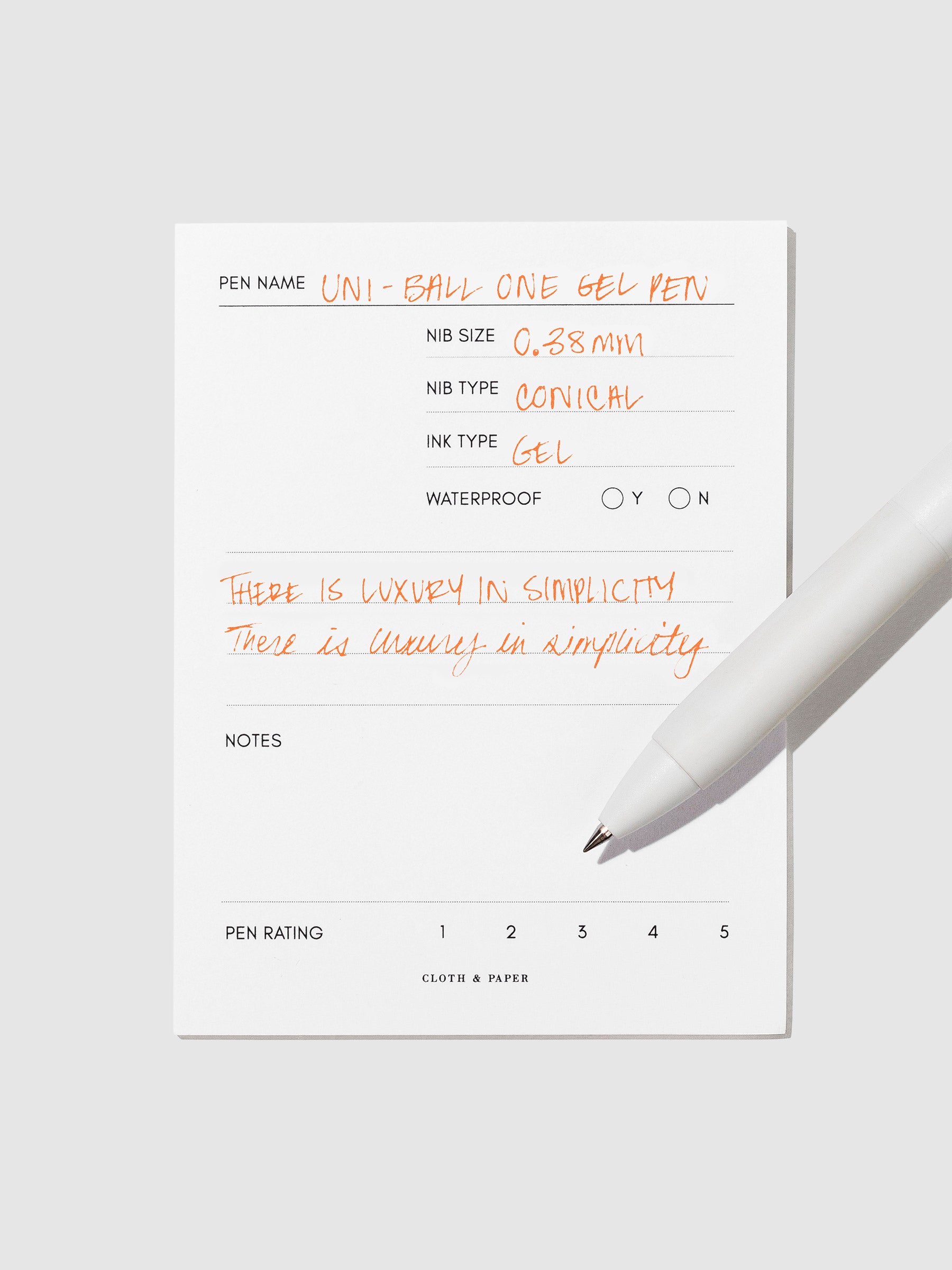 Pen tilted slightly to the right on a neutral background. Color pictured is Orange.