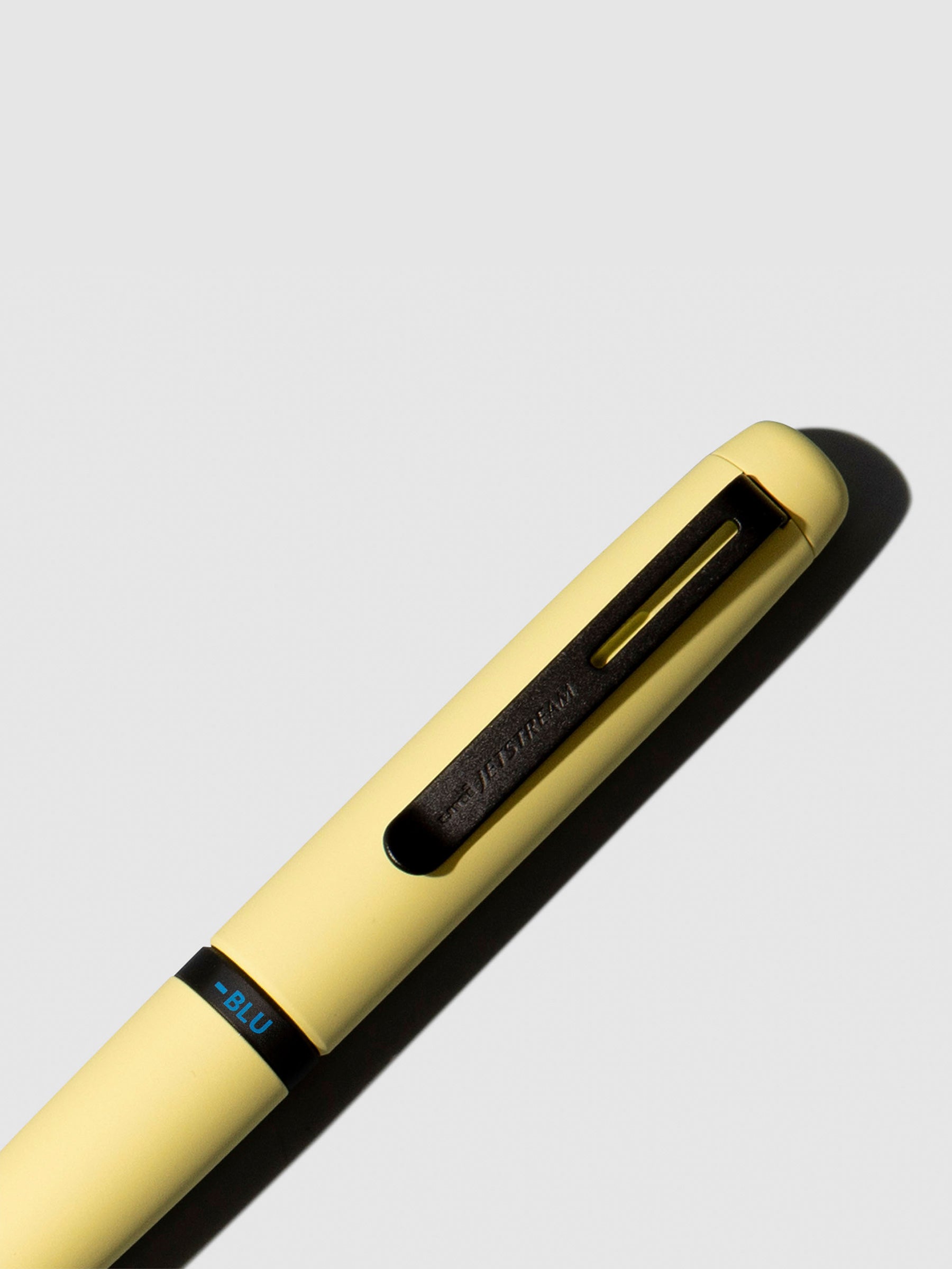 Pen shown close up, with the color selecting ring in focus. Pen ink color selected is blue, pen body is Citron Yellow.