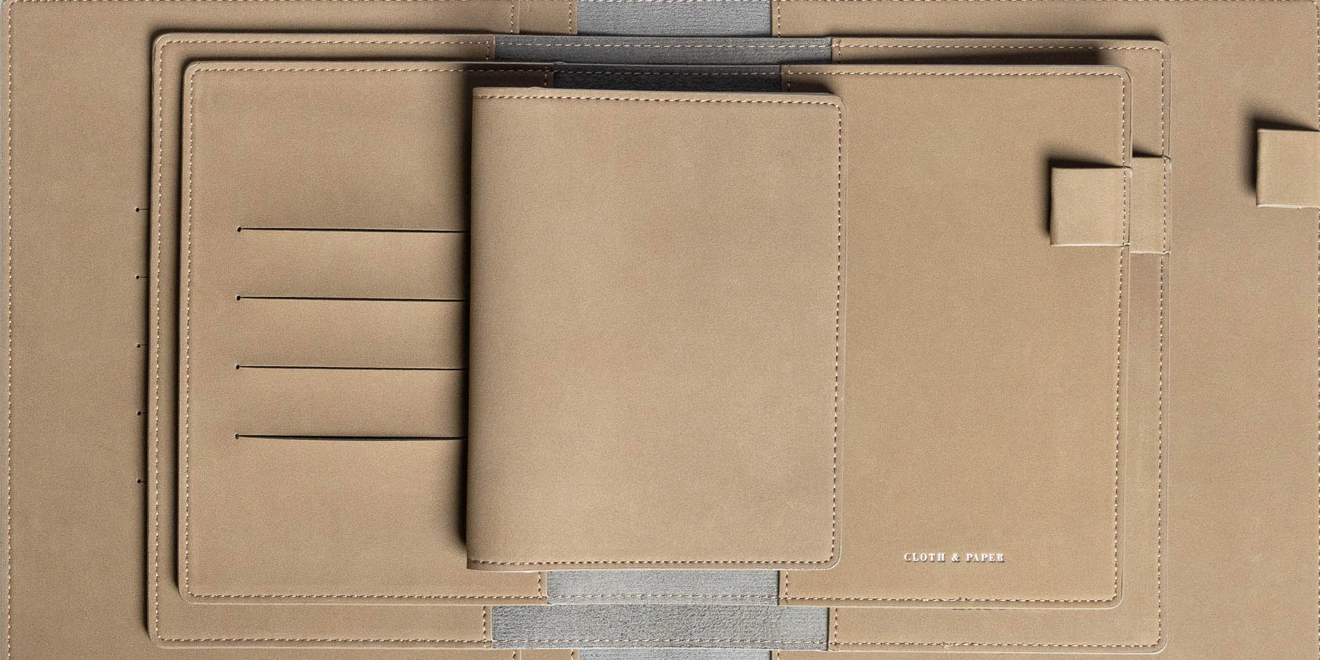 Set of suede colored Vegan Leather Folios in various sizes with some opened and lying flat.