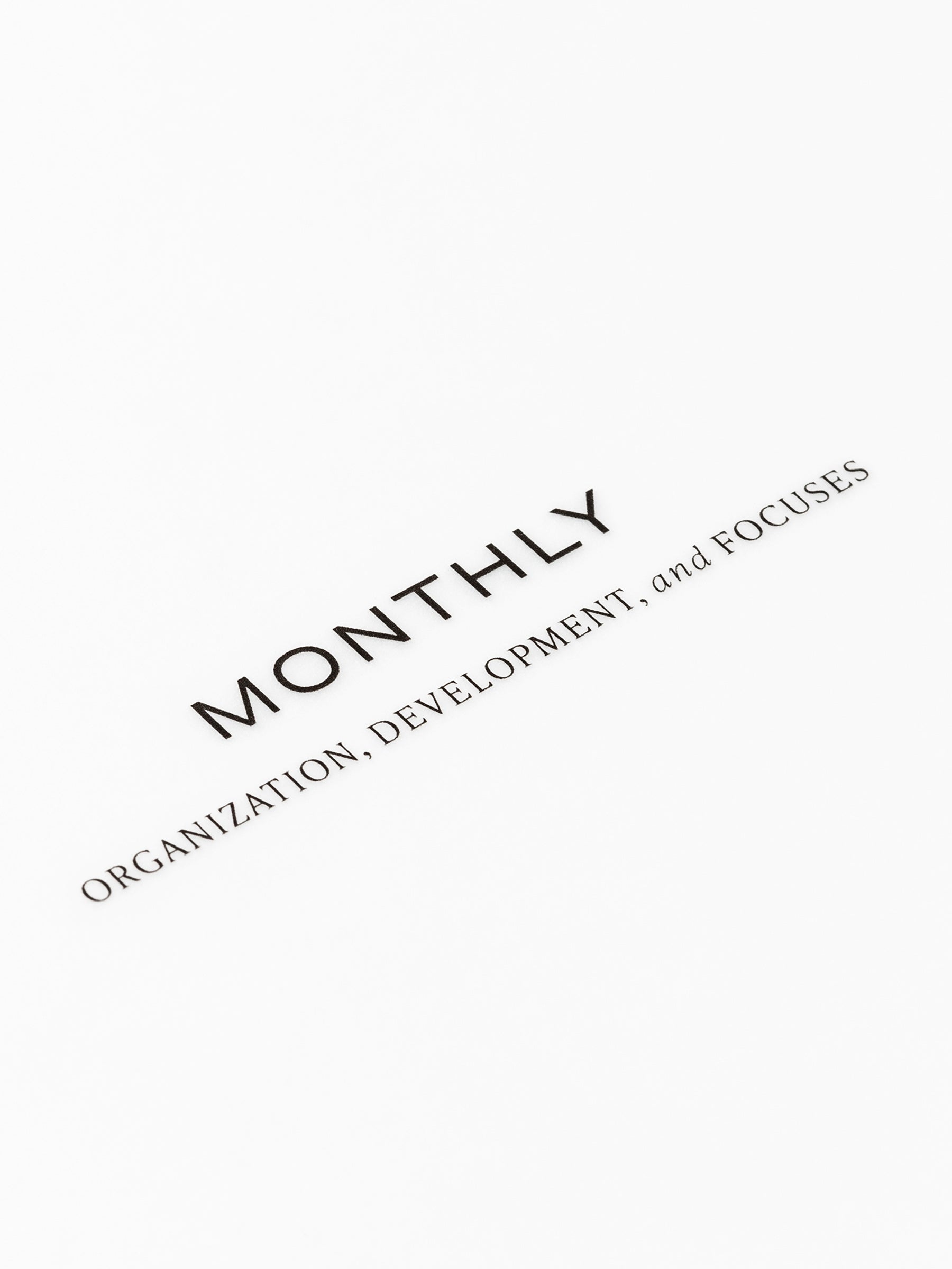Closeup of text reading "monthly | organization, development, and focuses"