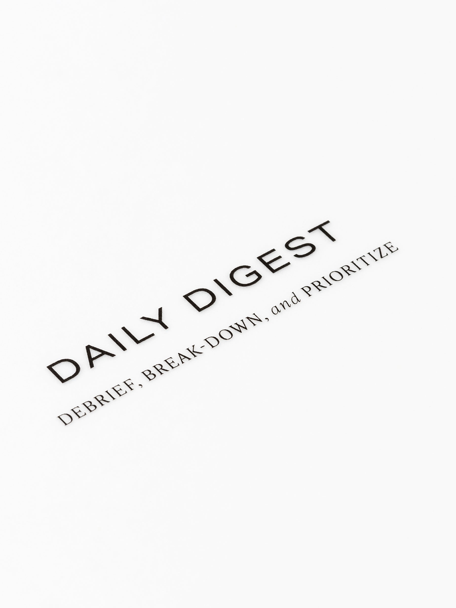 Closeup of text reading "daily digest | debrief, break-down, and prioritize"