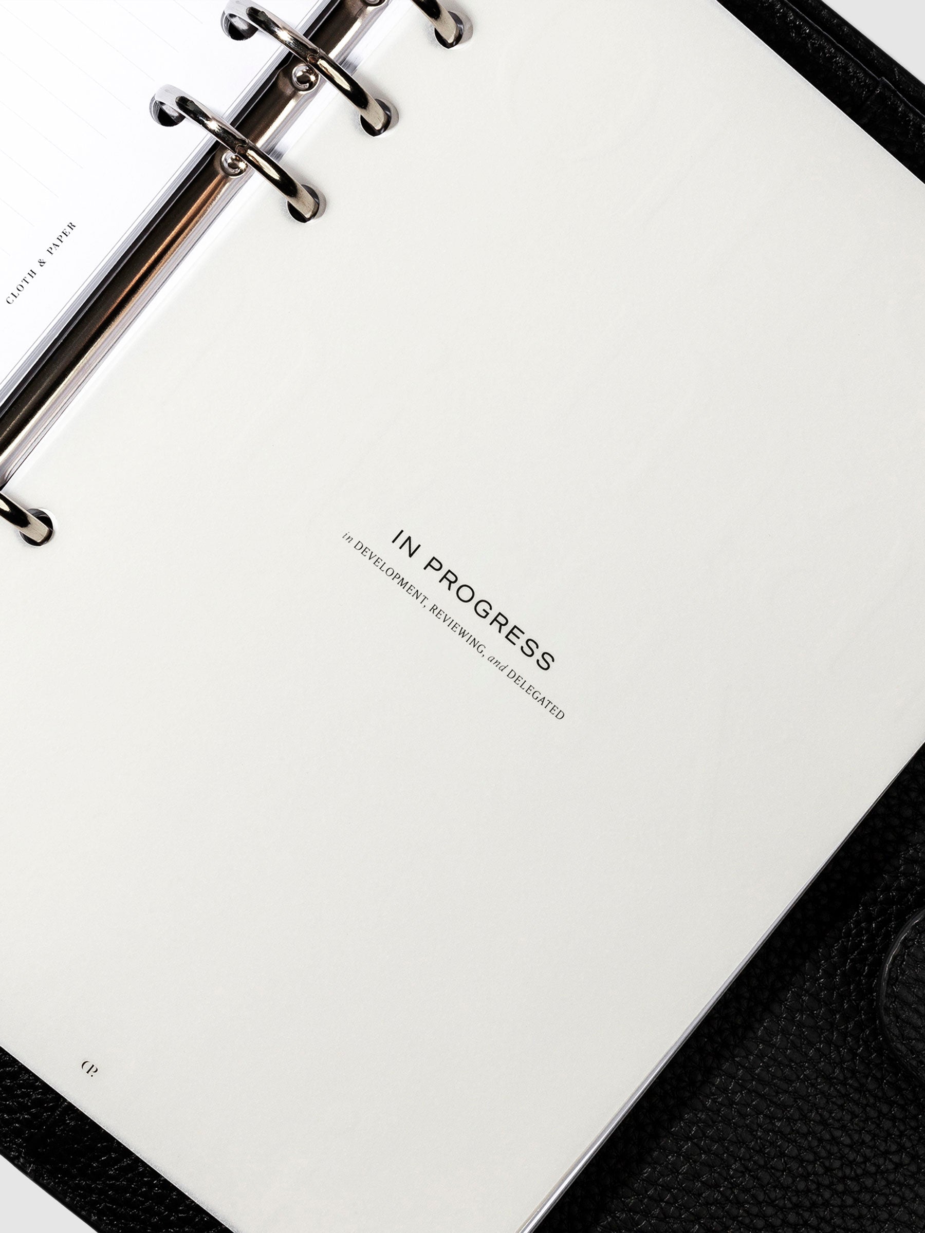 In Progress dashboard in use inside a leather planner.