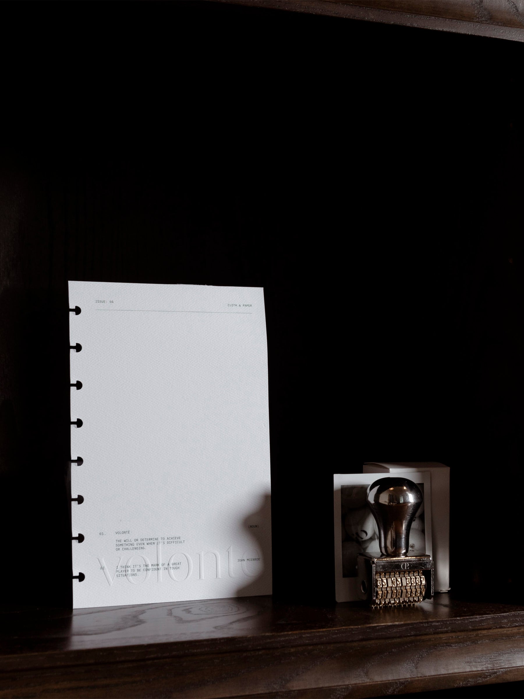Dashboard displayed inside a dark brown bookshelf. A Cloth and Paper date stamp is shown next to it.