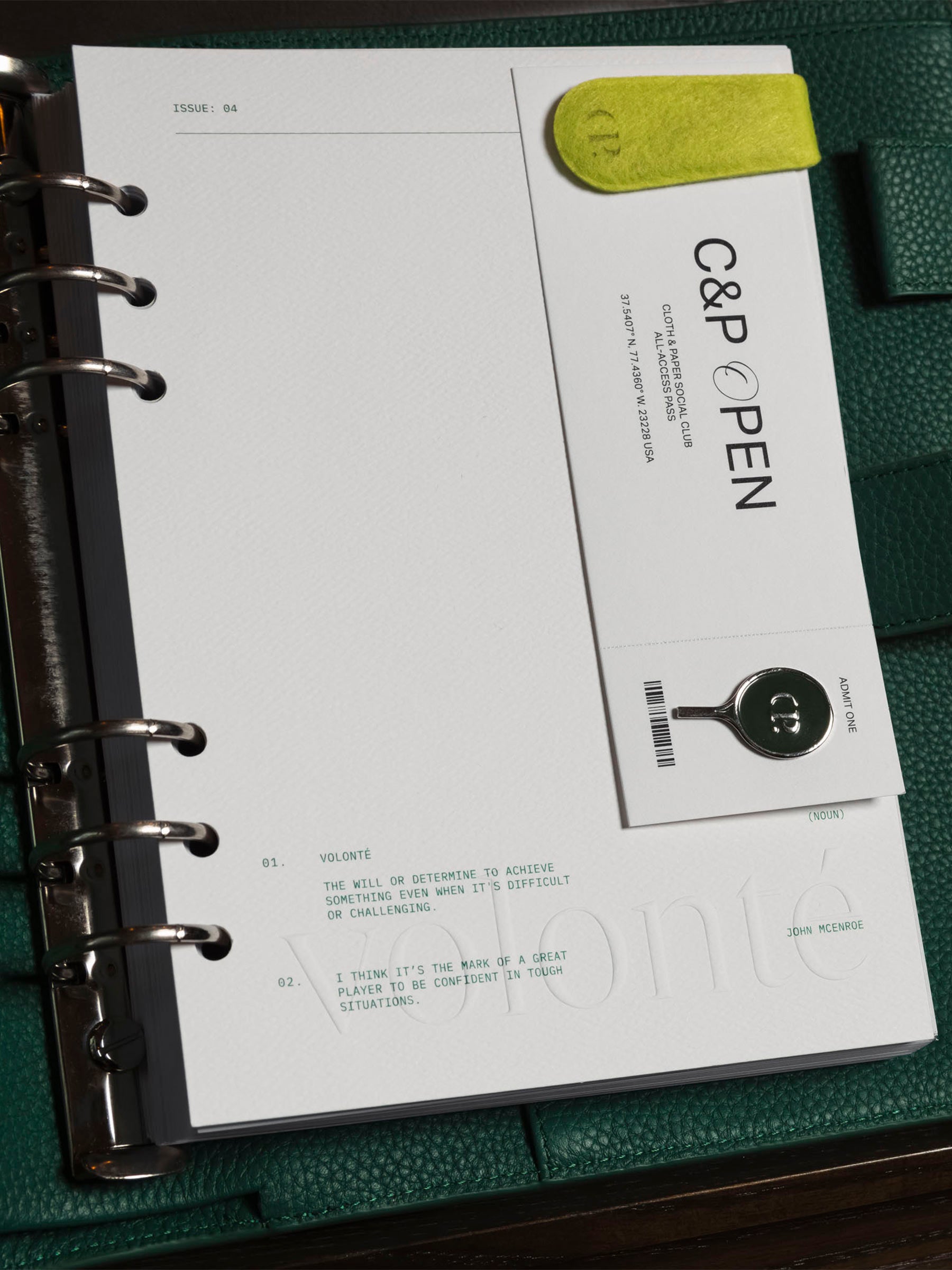 Dashboard shown inside a green leather agenda. It is decorated with a Cloth and Paperclip, enamel pin, and stickers.