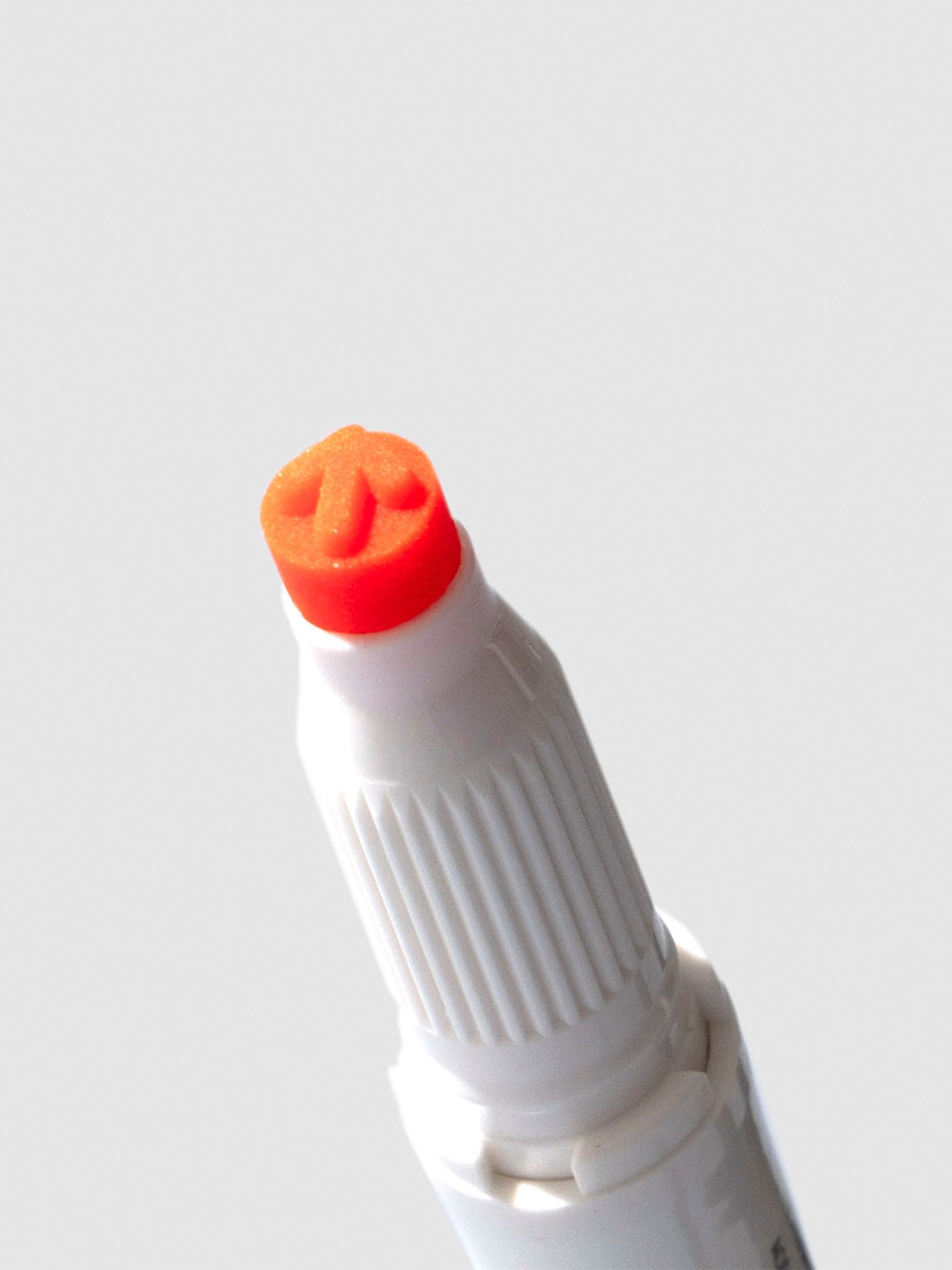 Closeup of apricot highlighter showing its arrow shaped tip.