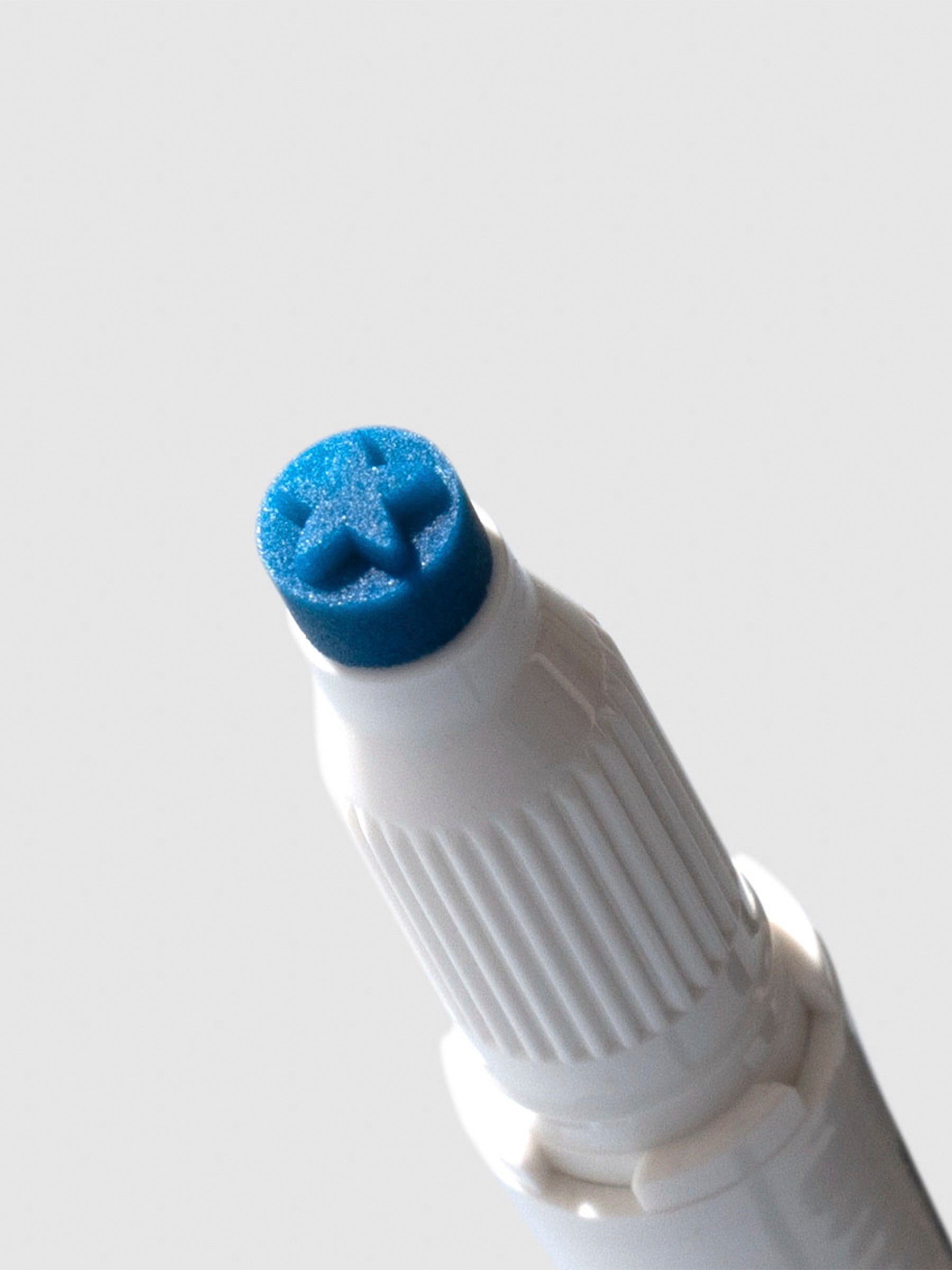 Closeup of cyan highlighter's star shaped tip.