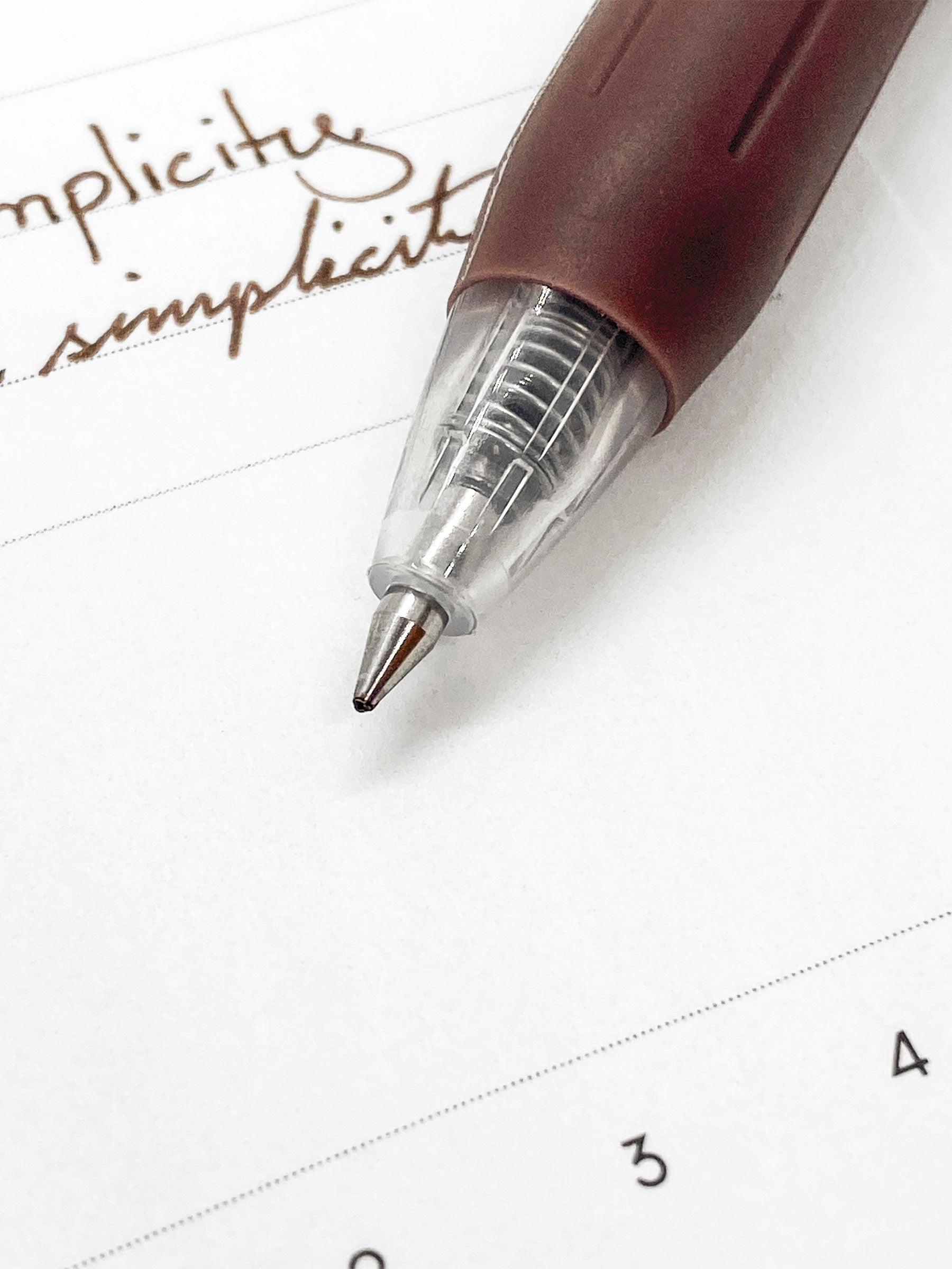 Zebra Sarasa Clip, 0.5 mm, Brown, Cloth and Paper. Close up on pen nib and writing sample.