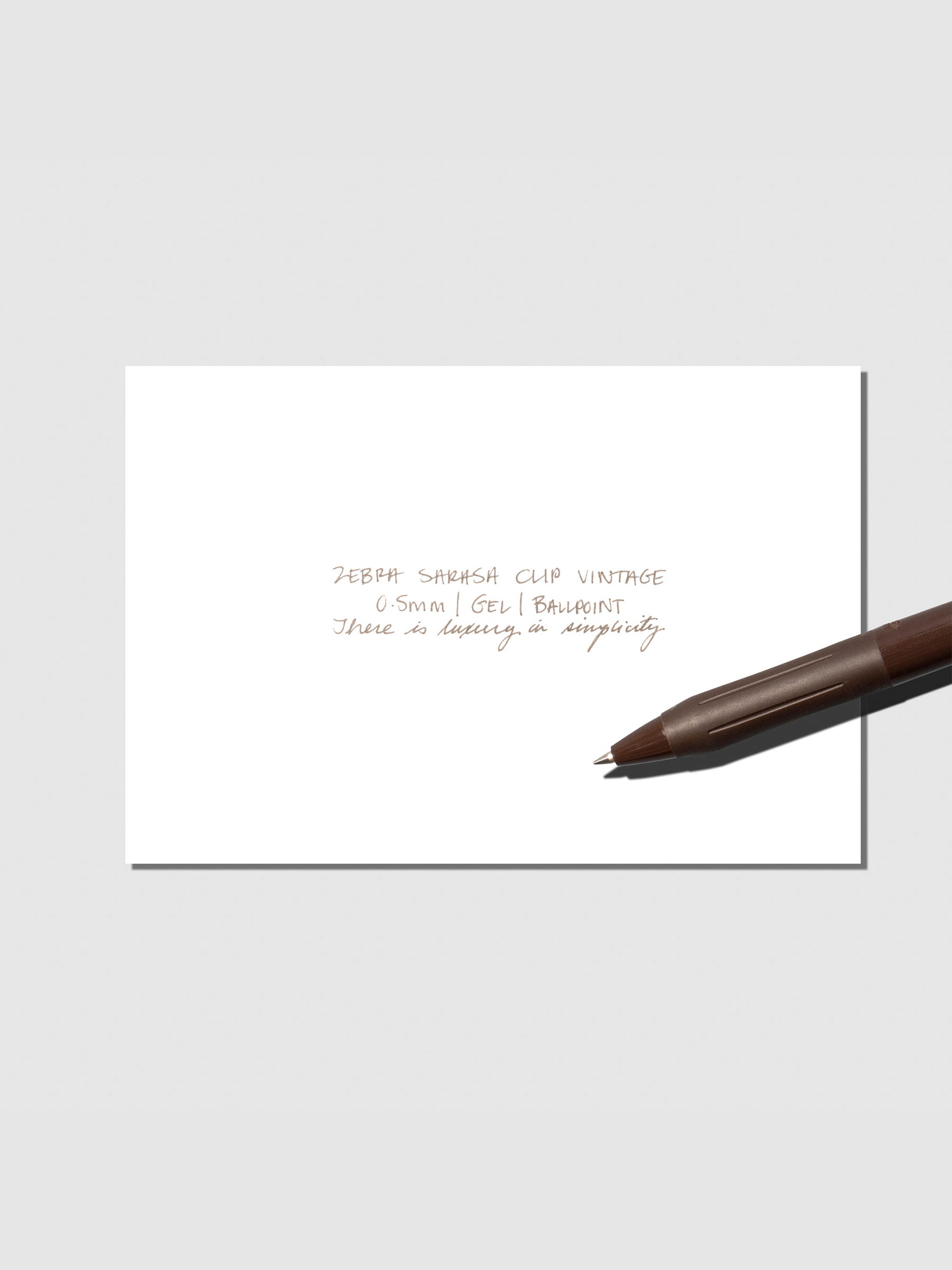Pen testing sheet displayed with pen on a neutral background. Color shown is Brown Grey.