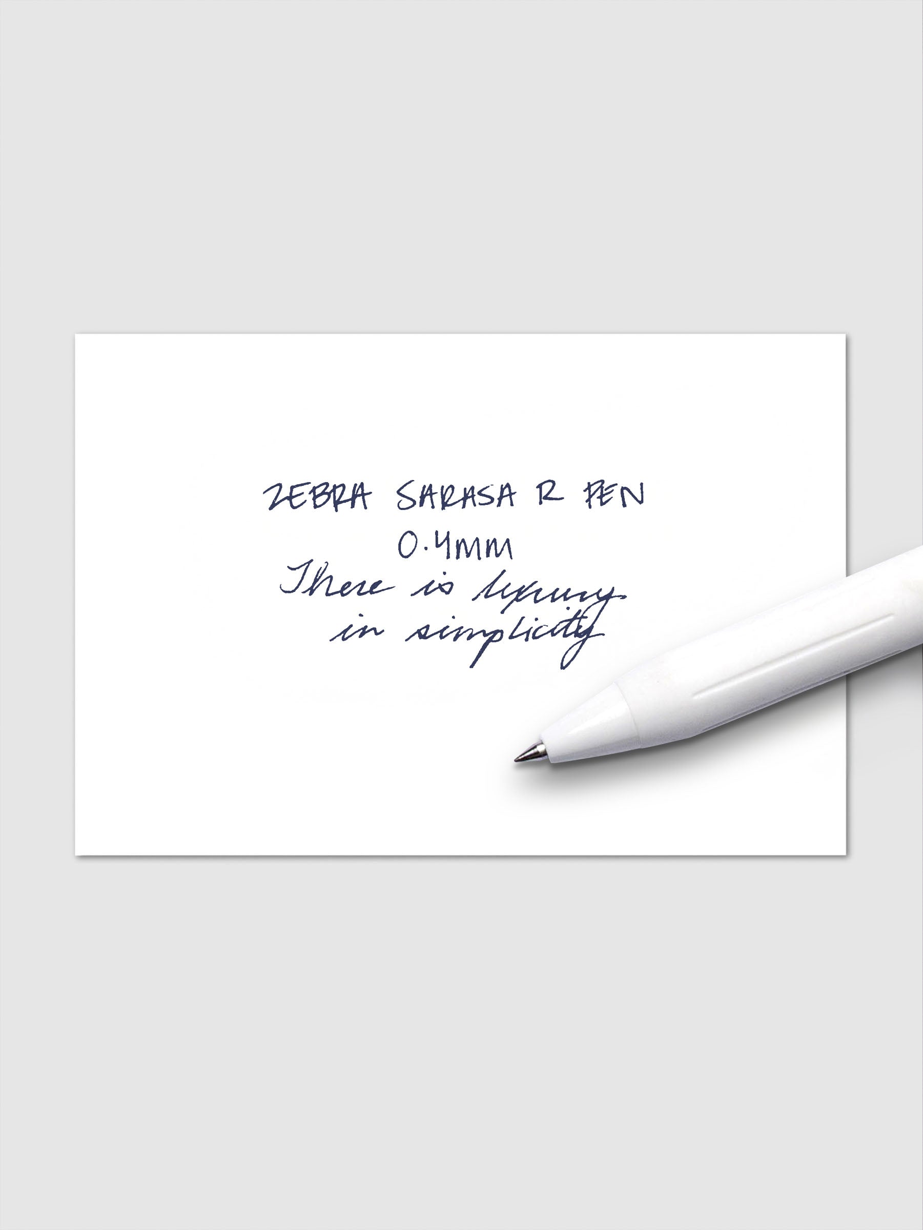 Writing sample using Zebra Sarasa R 0.4mm pen in blue-black ink on white paper.