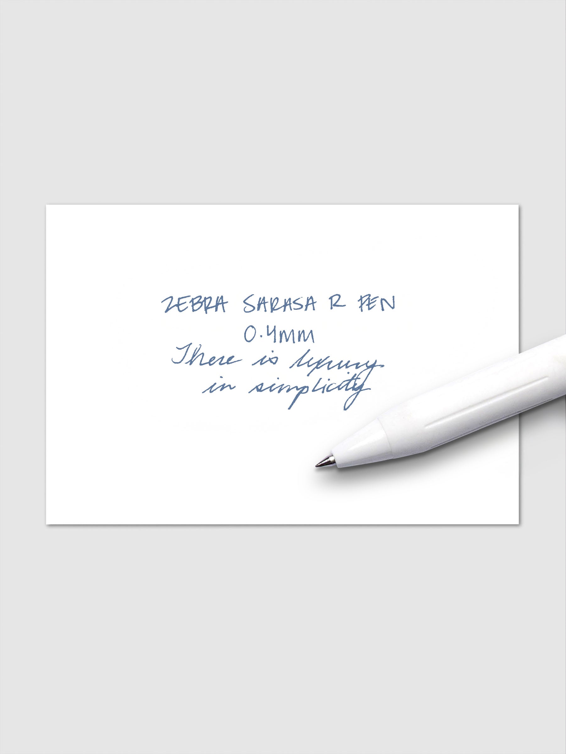 Writing sample using Zebra Sarasa R 0.4mm pen in blue-grey ink on white paper.