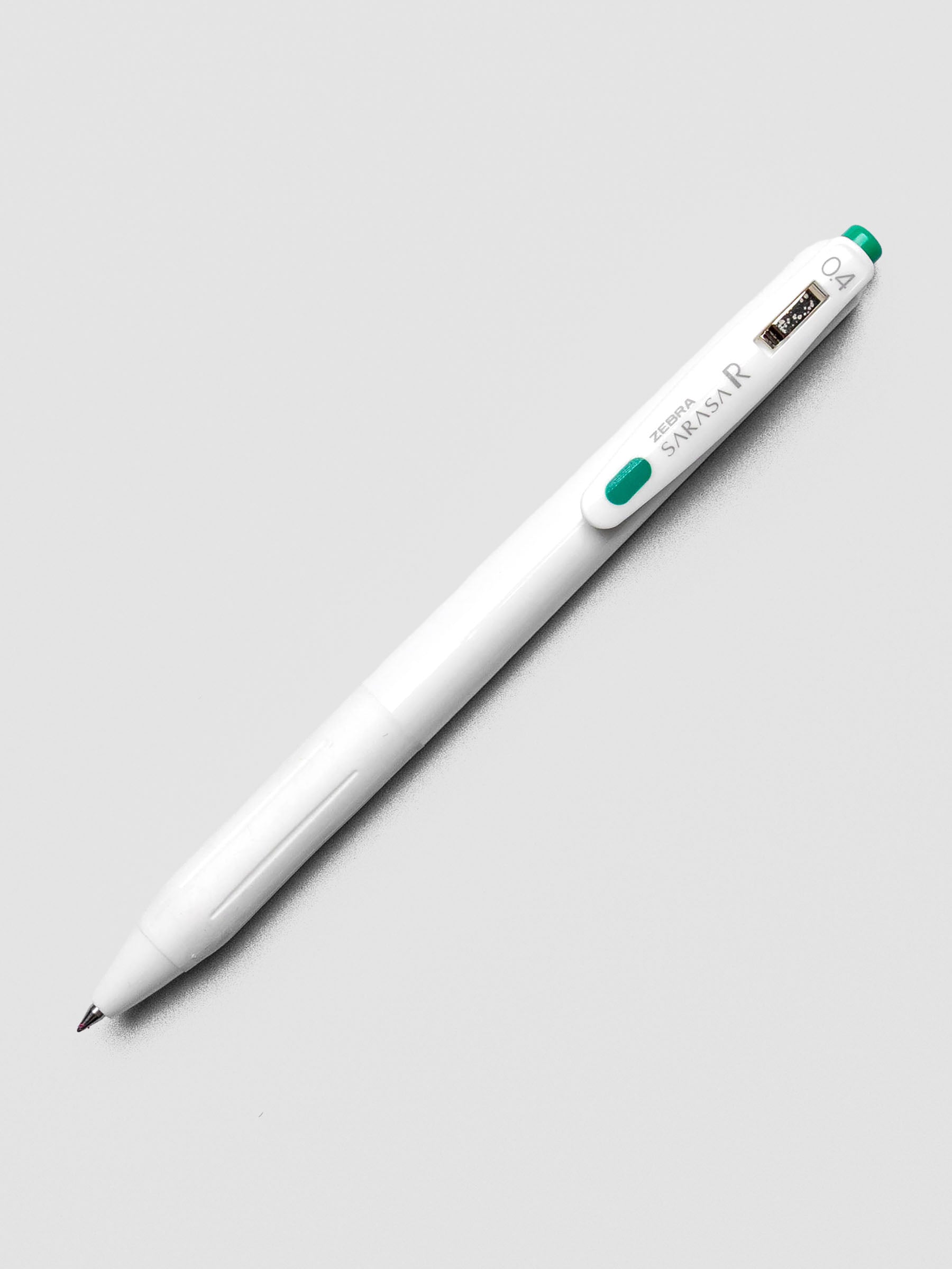 Zebra Sarasa R 0.4mm pen in green ink with matching clip, displayed on a white background.