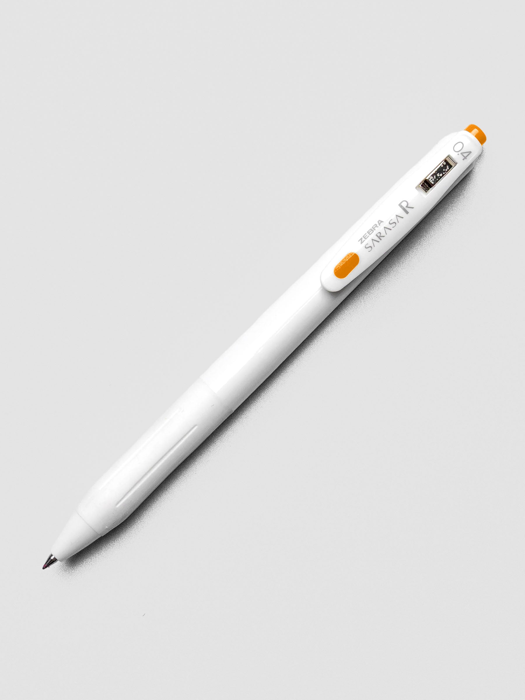 Zebra Sarasa R 0.4mm pen in orange ink with matching clip, shown on a white background.