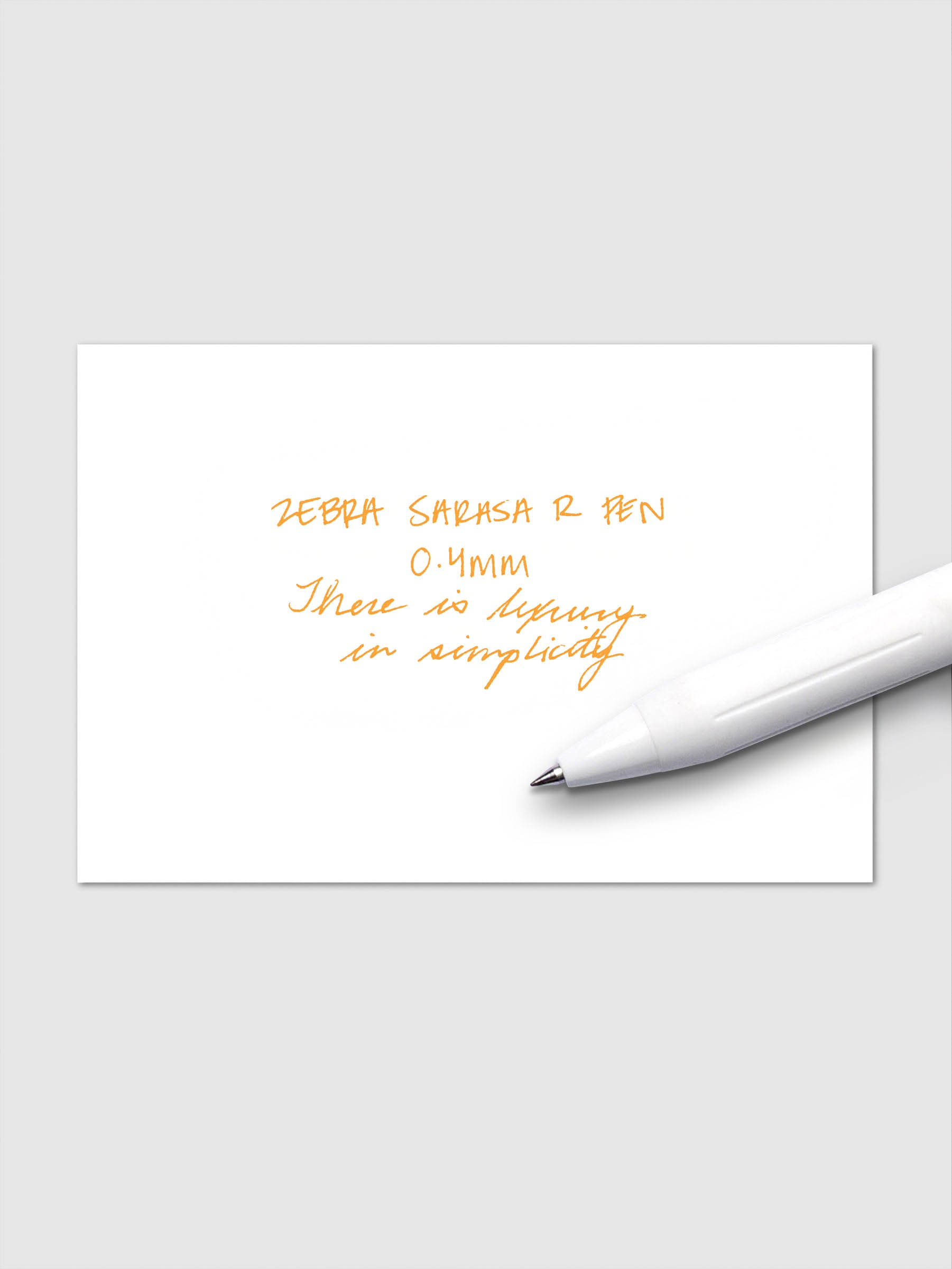 Writing sample using Zebra Sarasa R 0.4mm pen in orange ink on white paper.