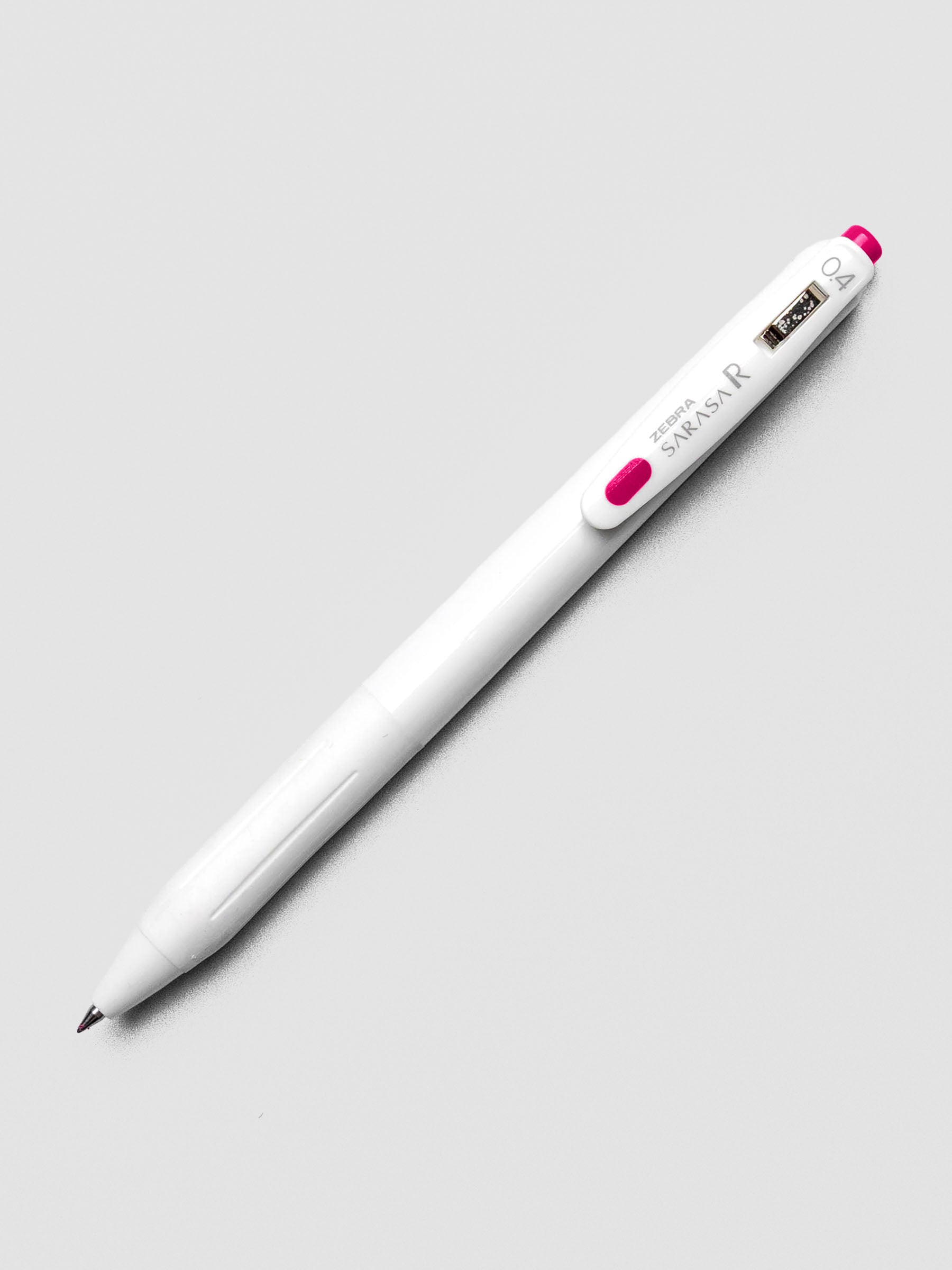 Zebra Sarasa R 0.4mm pen in pink ink with matching clip, displayed on a white background.