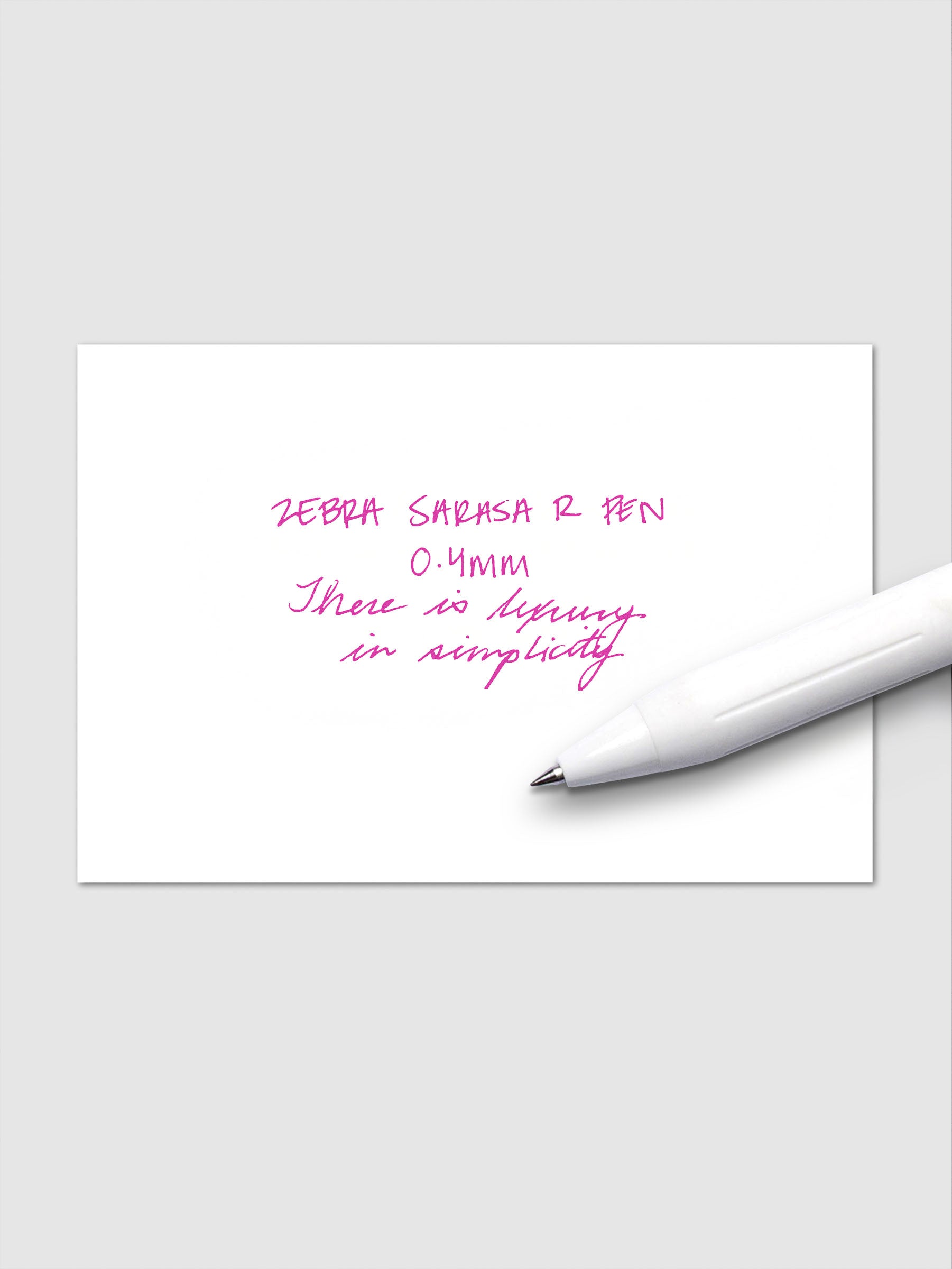 Writing sample using Zebra Sarasa R 0.4mm pen in pink ink on white paper.