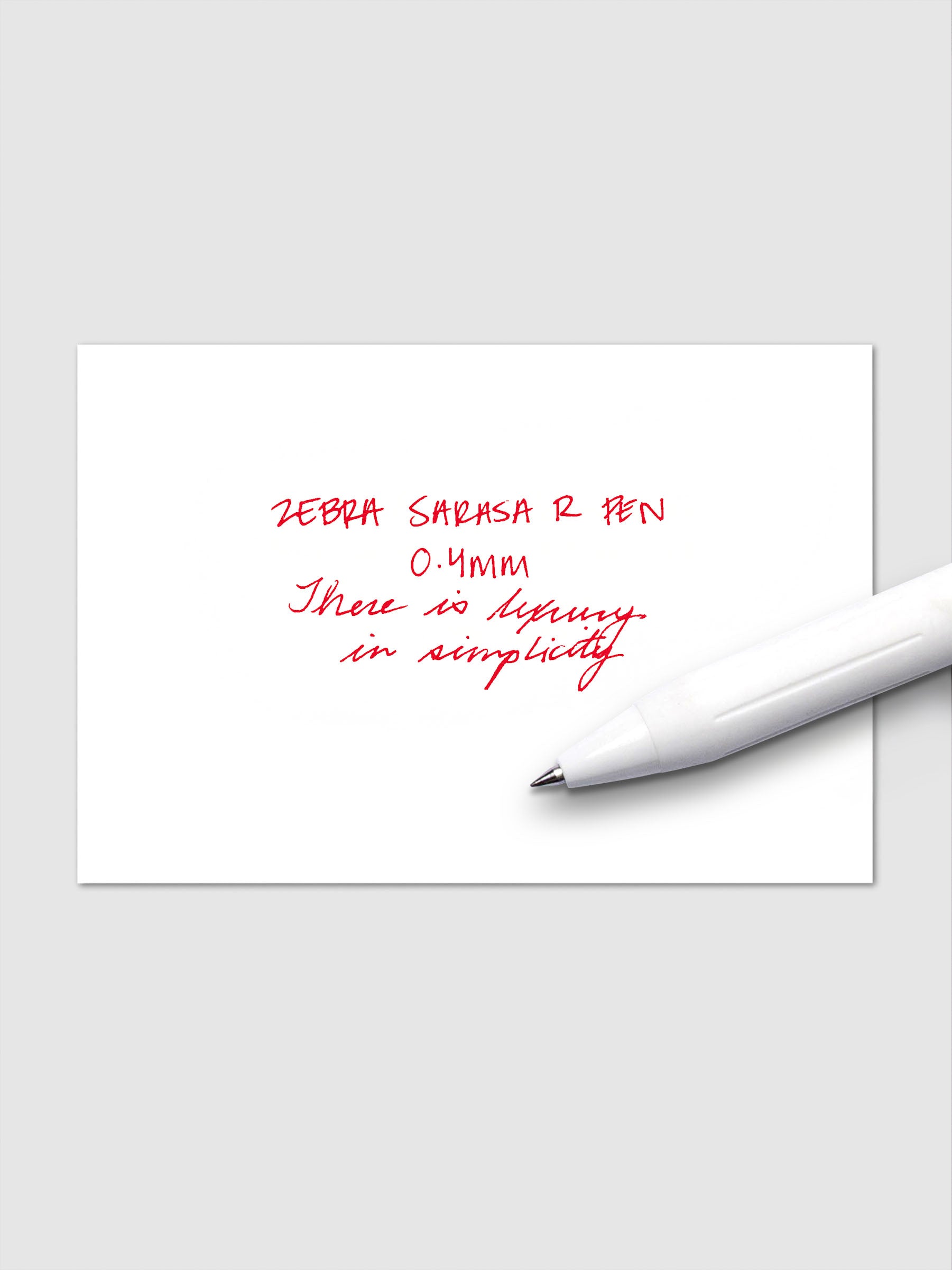 Writing sample using Zebra Sarasa R 0.4mm pen in red ink on white paper.