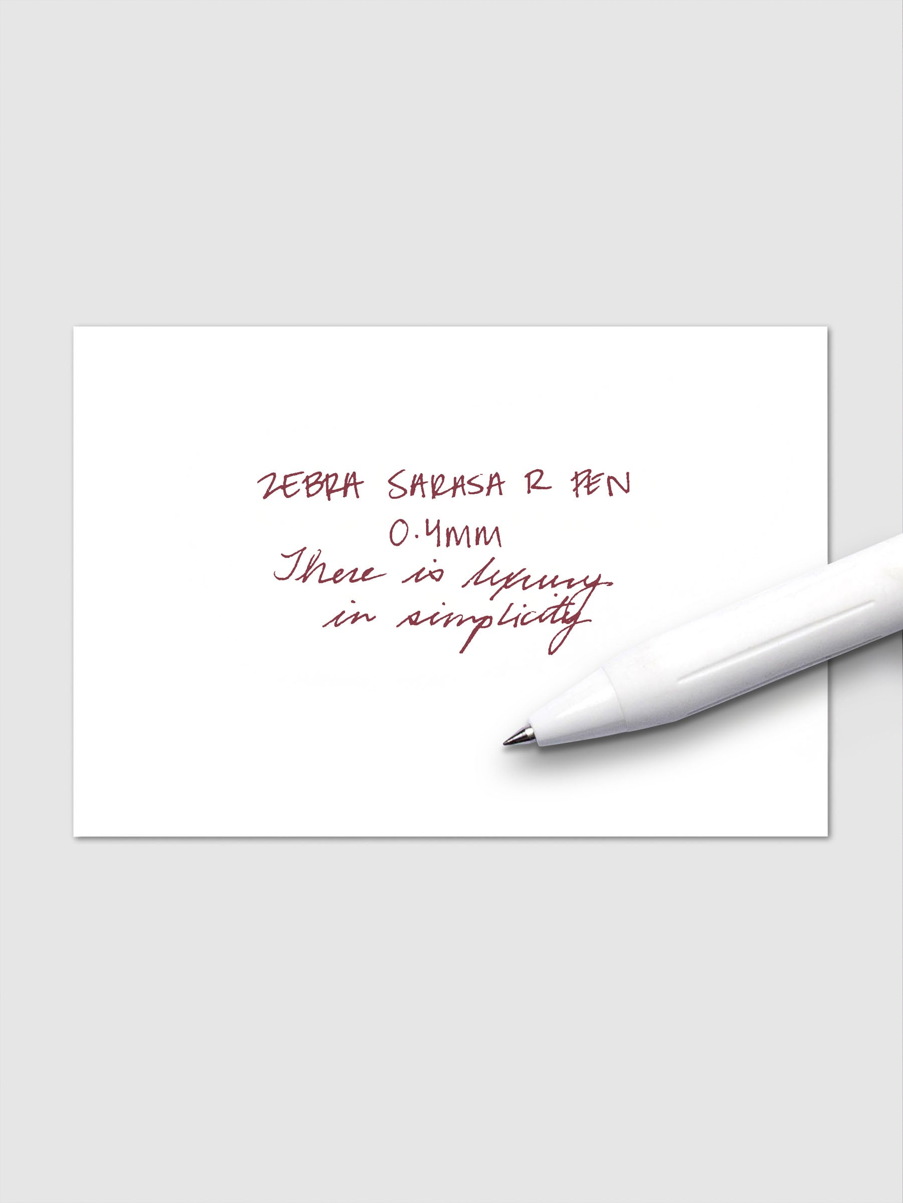Writing sample using Zebra Sarasa R 0.4mm pen in red-black ink on white paper.