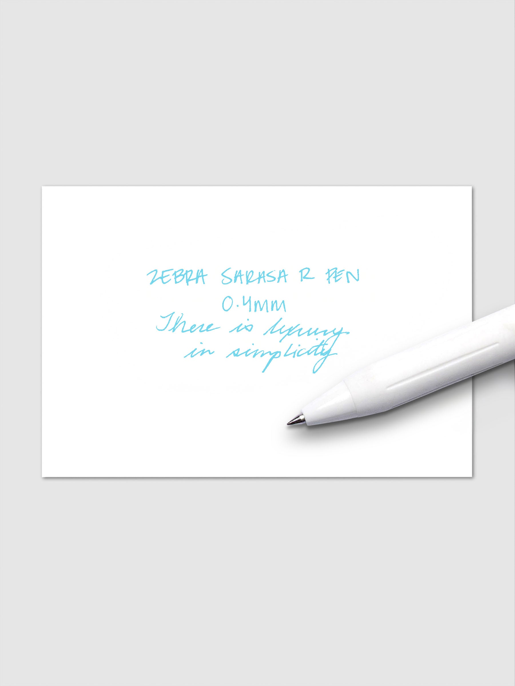 Writing sample using Zebra Sarasa R 0.4mm pen in sky blue ink on white paper.