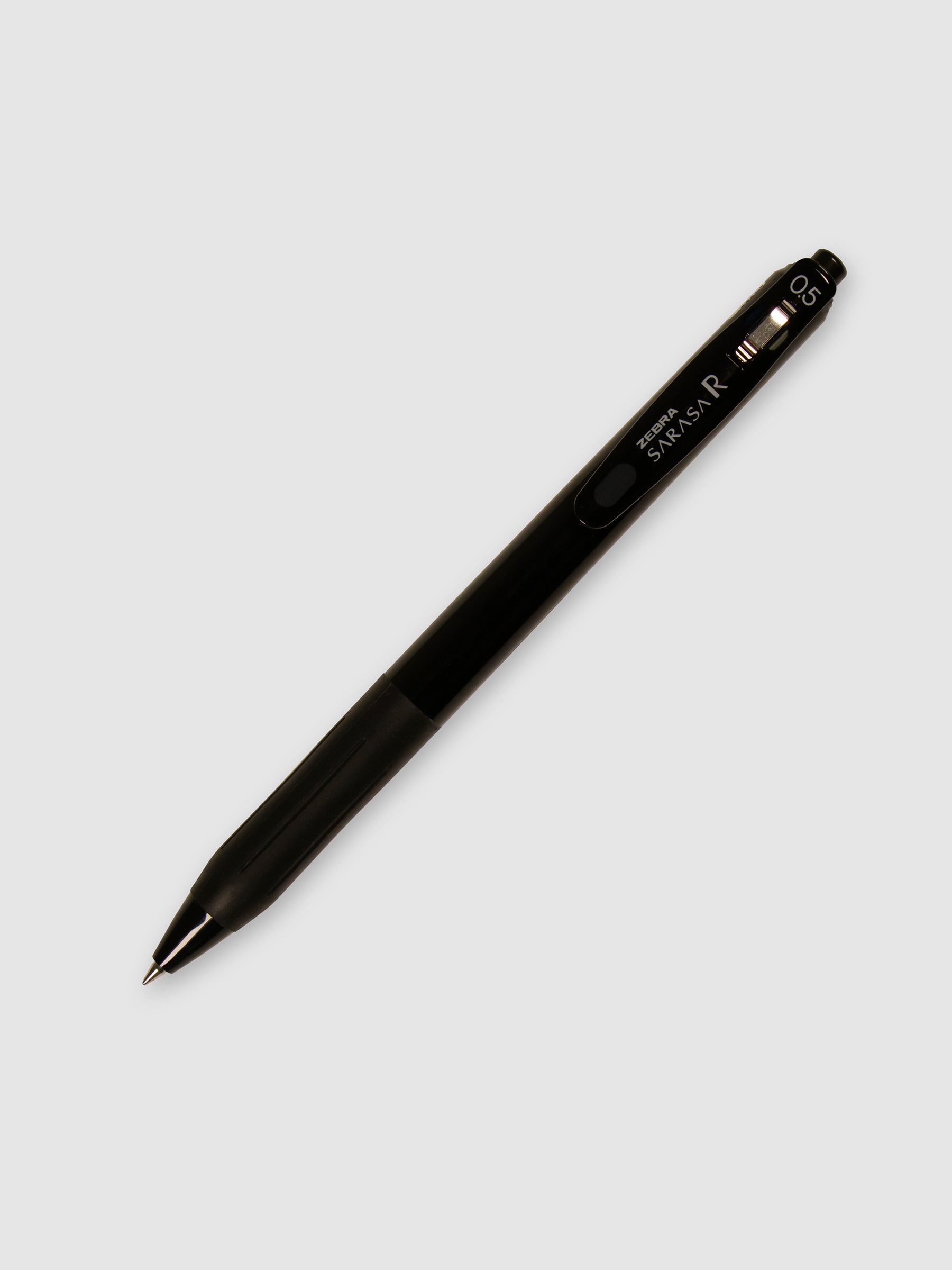 Zebra Sarasa R Pen, 0.5 mm, Black Ink, Black Body, Cloth and Paper. Pen with nib exposed turned to the right against a neutral background.