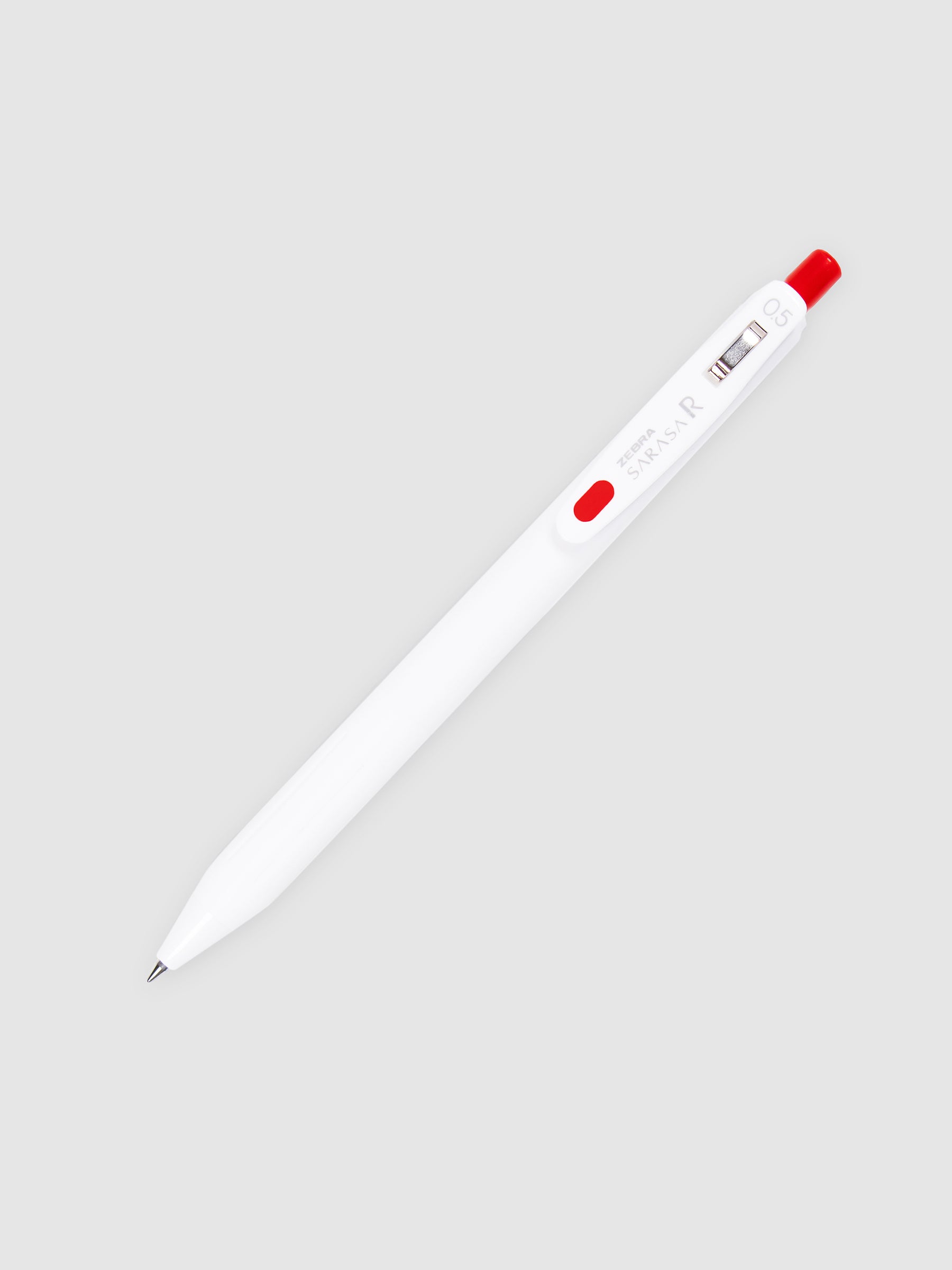 Zebra Sarasa R Pen, 0.5 mm, Red, Cloth and Paper. Pen with nib exposed turned to the right against a neutral background.