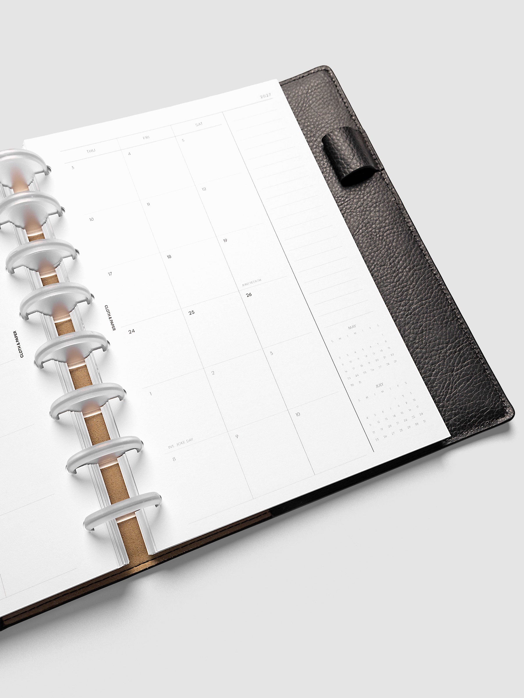 Close-up of the 2027 Dated Monthly Sunday Start right page in Half Letter 8-Disc Punch size, showing the mini calendars for the prior and following month in the bottom right corner