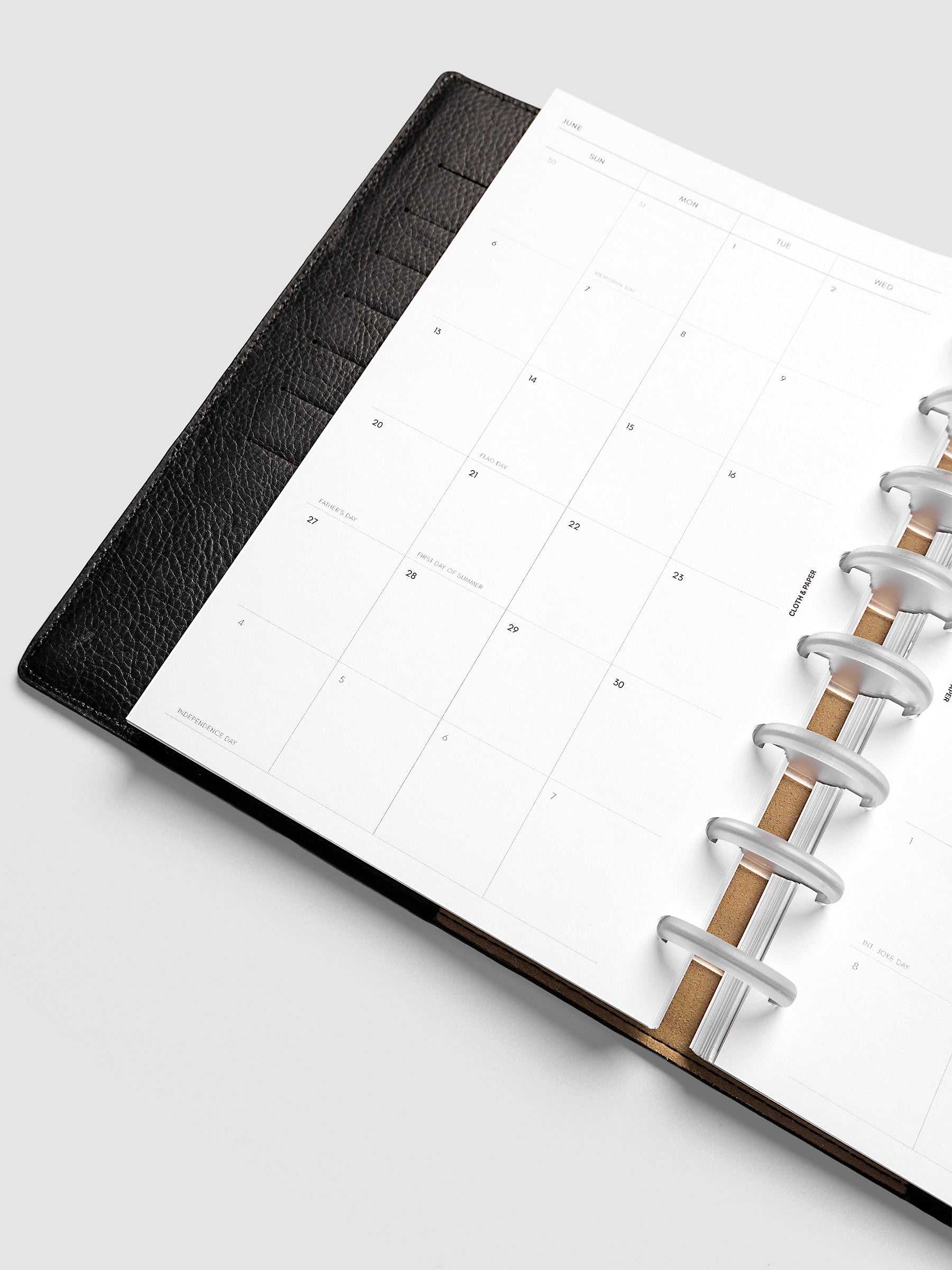 Close-up of the 2027 Dated Monthly Sunday Start left page in Half Letter 8-Disc Punch size, showing the dated calendar grid and day cell