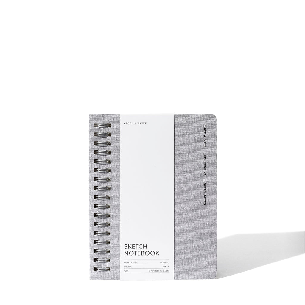 Linen notebook displayed with its packaging on a white background.