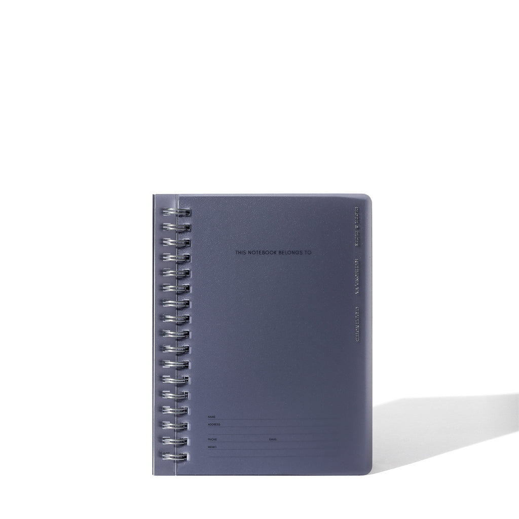 Tinted plastic notebook displayed on a white background.