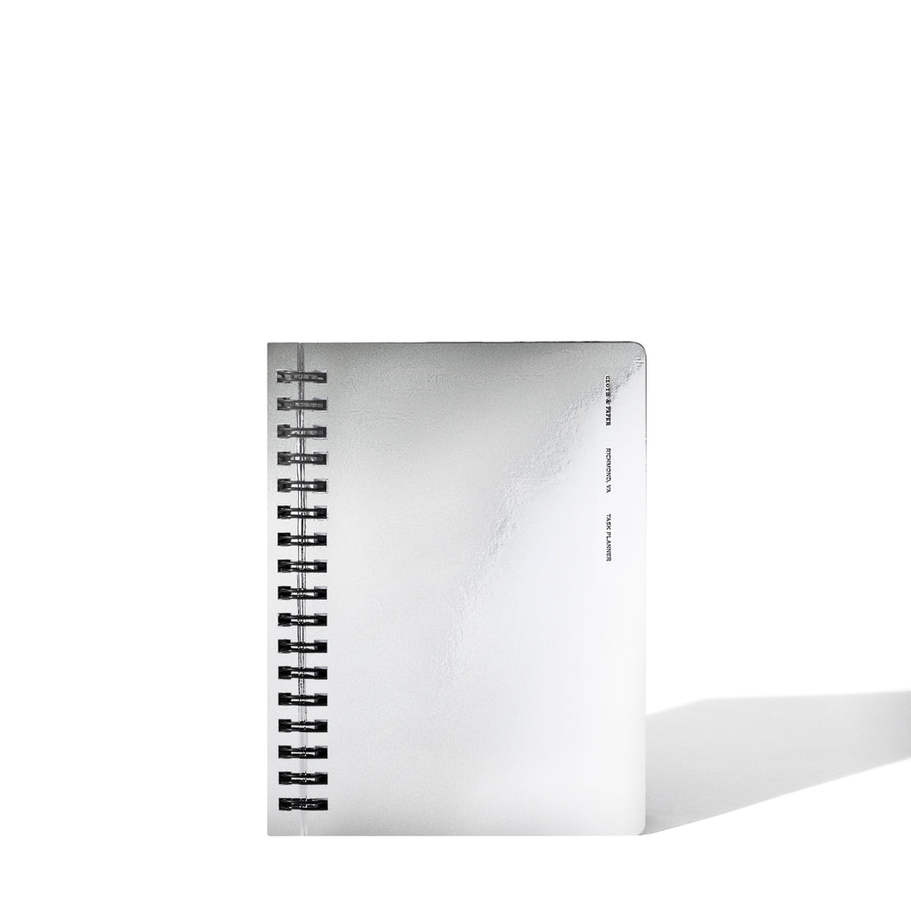 Silver notebook displayed on a white background.