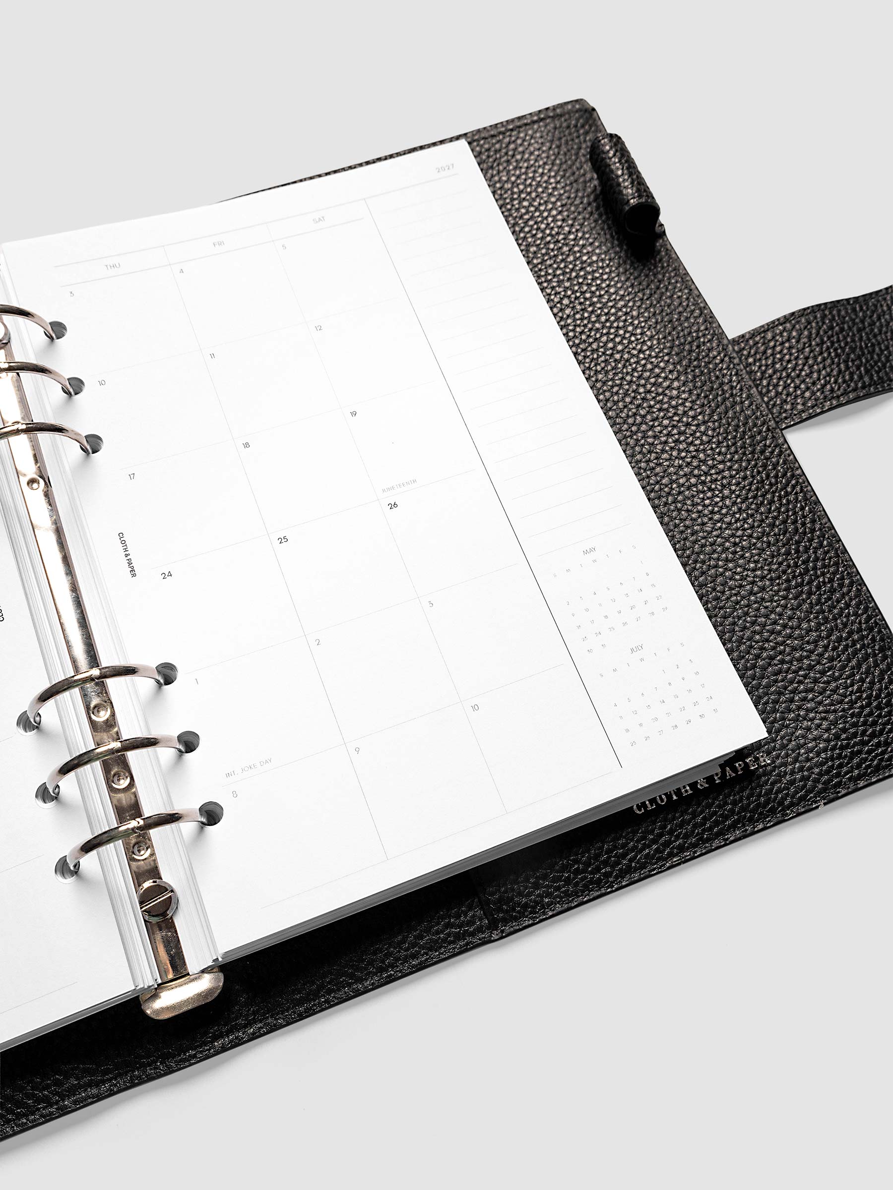 Close-up of the 2027 Dated Monthly Sunday Start right page in A5 6-Ring Punch size, showing the mini calendars for the prior and following month in the bottom right corner