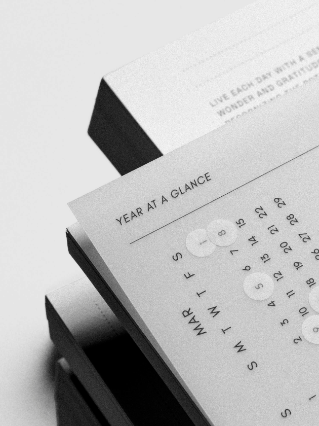 A monochrome close-up of a Year at a Glance Planner Dashboard showing monthly calendar grids in a clean, minimalist layout.