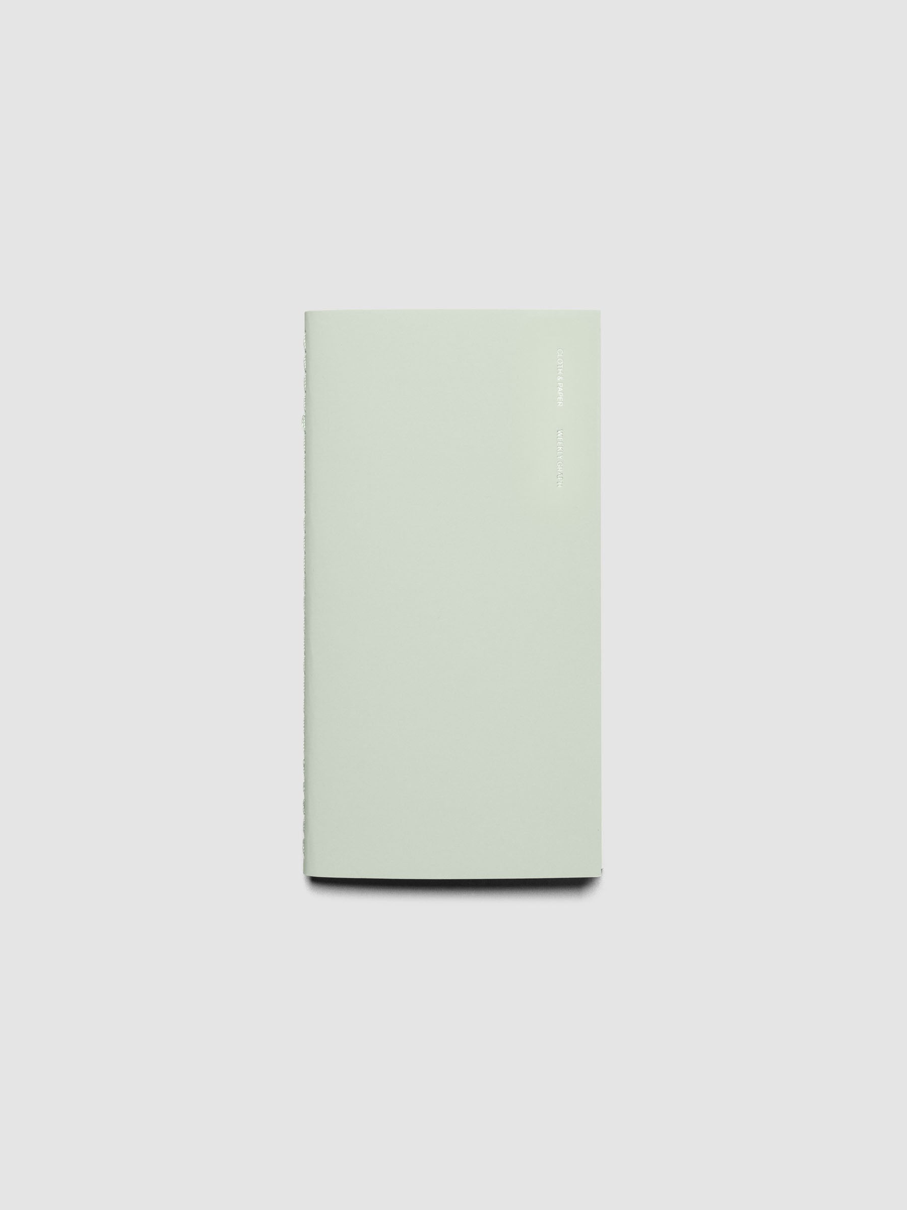 Travel Notebook, Weekly Graph Style, Matcha, Cloth and Paper. Notebook displayed closed on a neutral background.