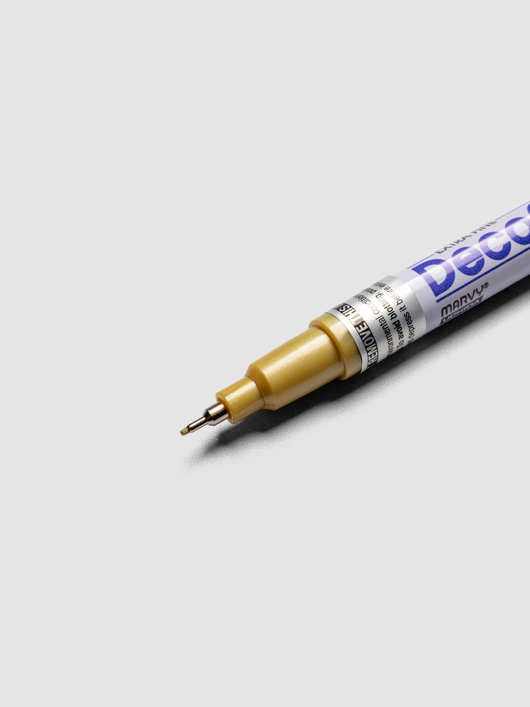 Close up of the Gold DecoColor paint marker in extra fine showing the nib